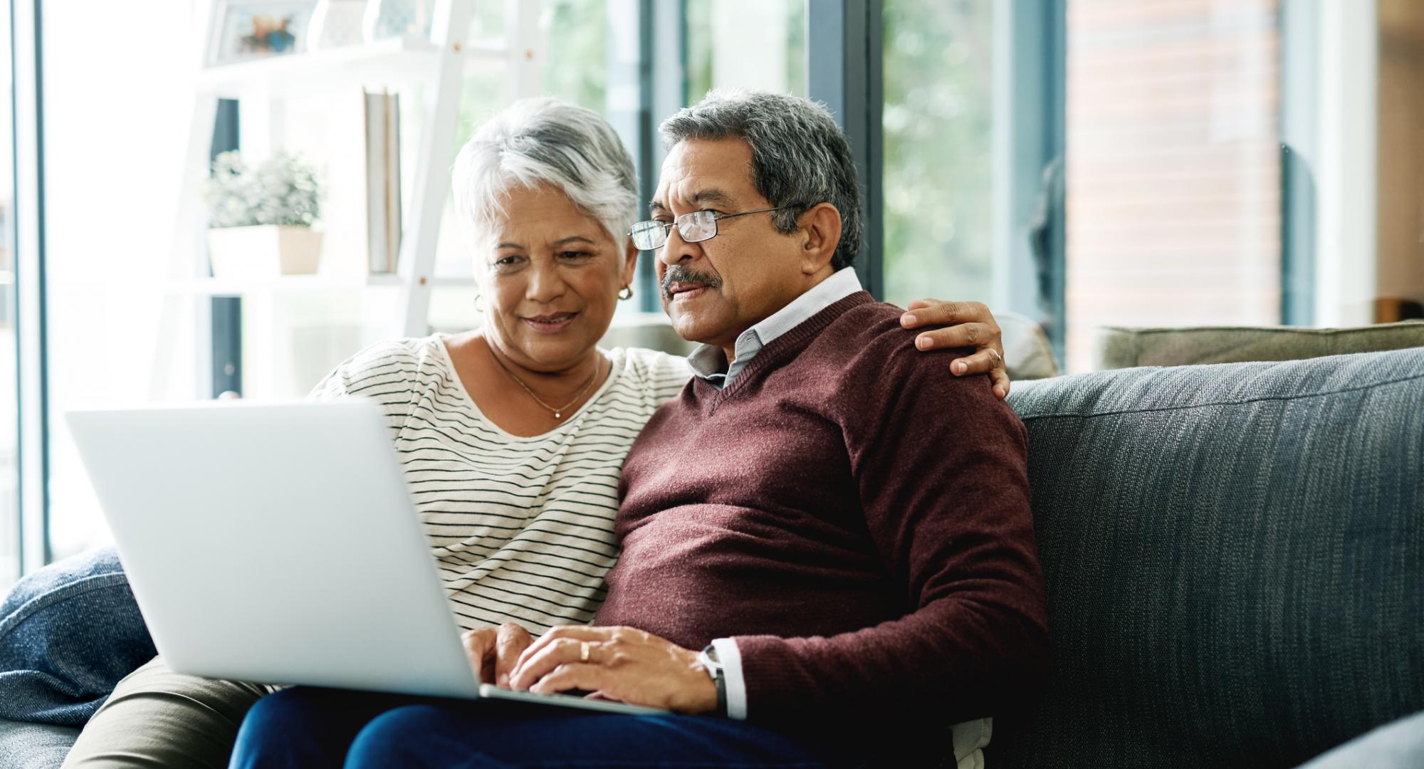 Elderly couple on laptop at home