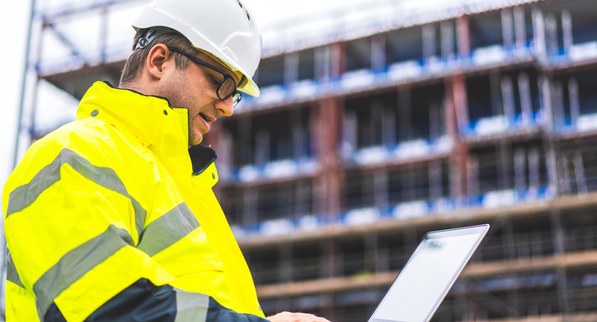 Engineer on building site with laptop