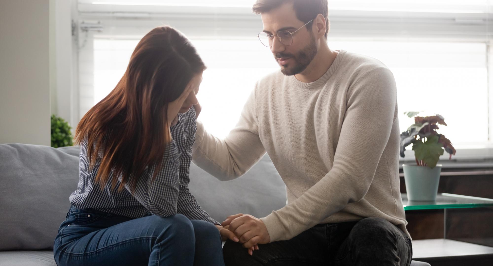 Man consoling woman