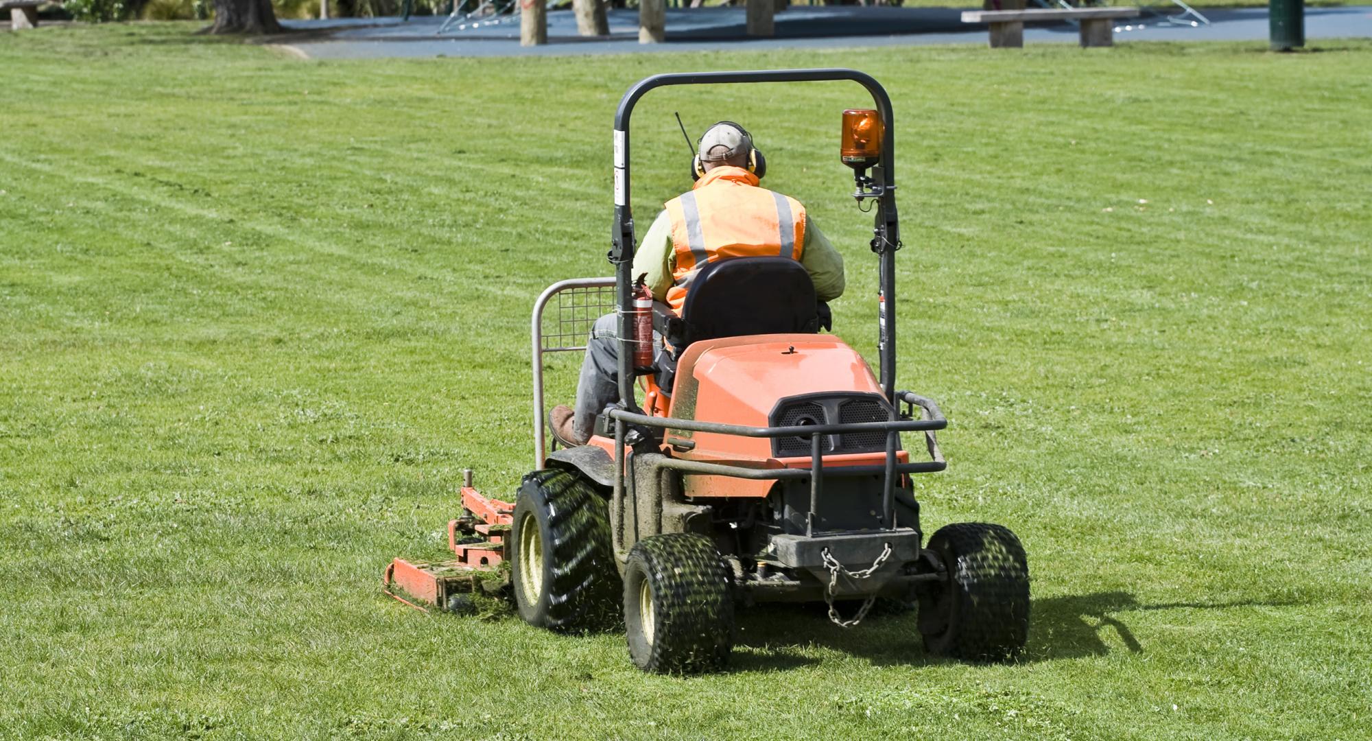 Man cutting grass on lawn moer