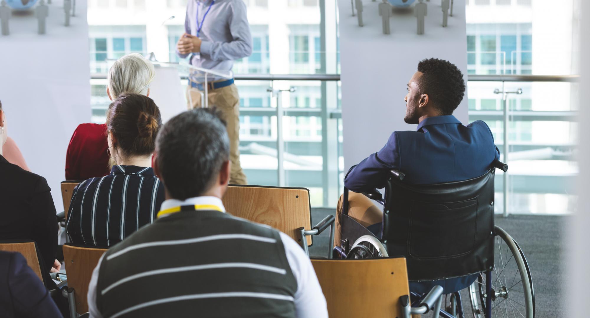 Man in wheelchair at business meeting