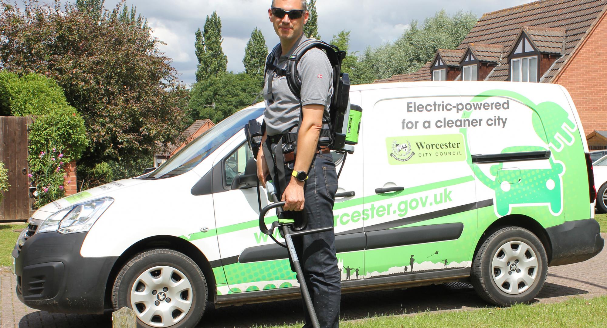 Councillor Andy Stafford with the electric grass strimmer