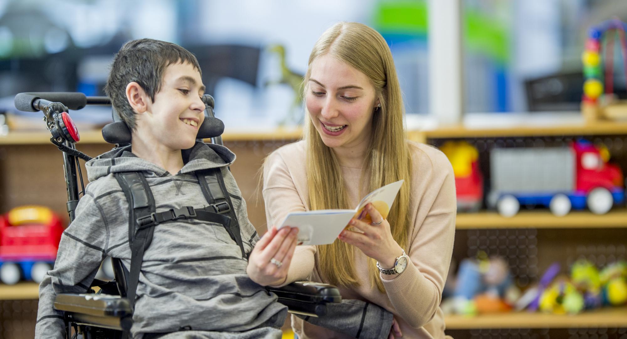 Learning disabilities worker helping a child