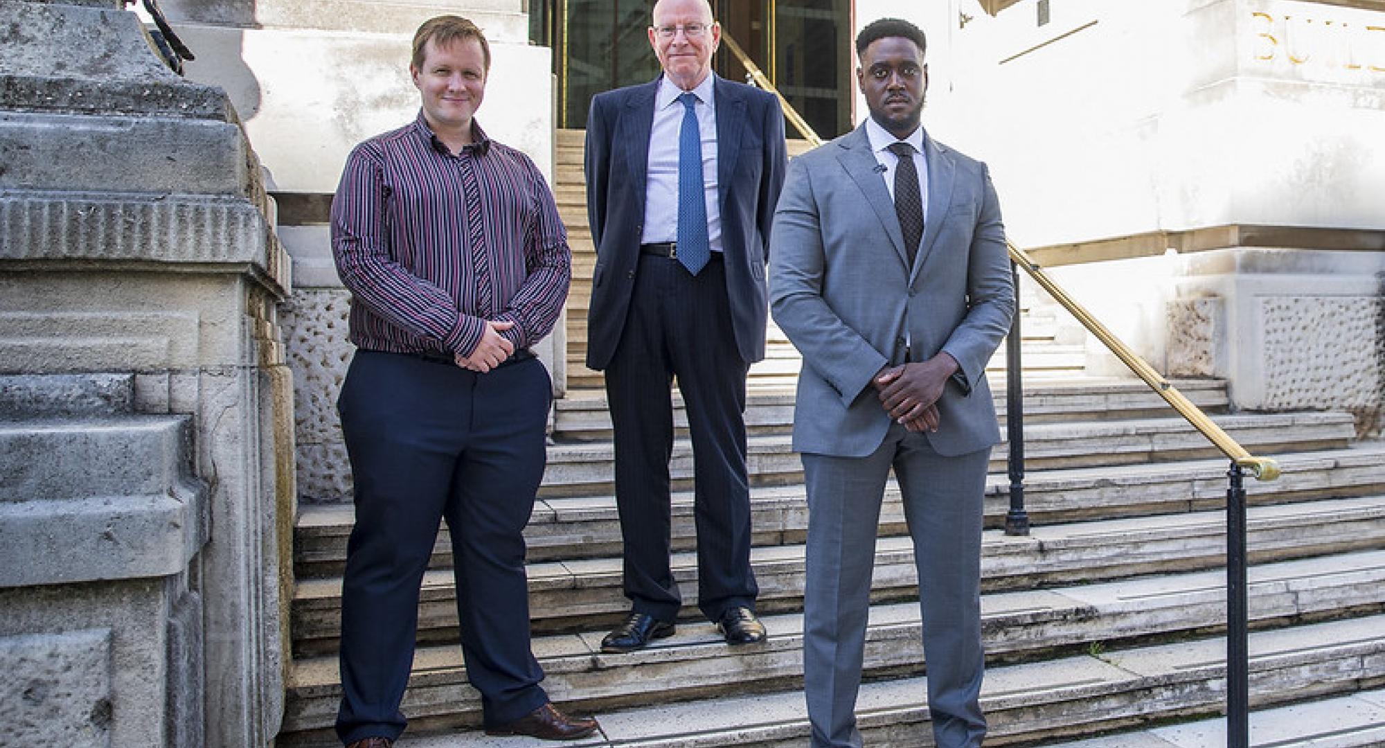 Councillor Kris Brown with new committee advisers Stephen Gregory and Ramone Johnson