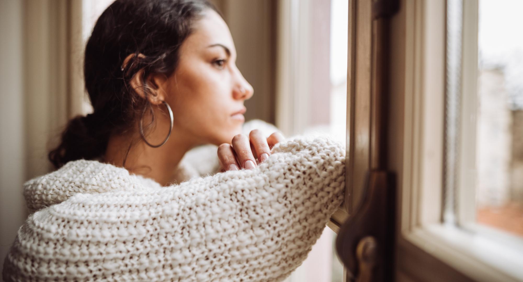 Young woman looking out window