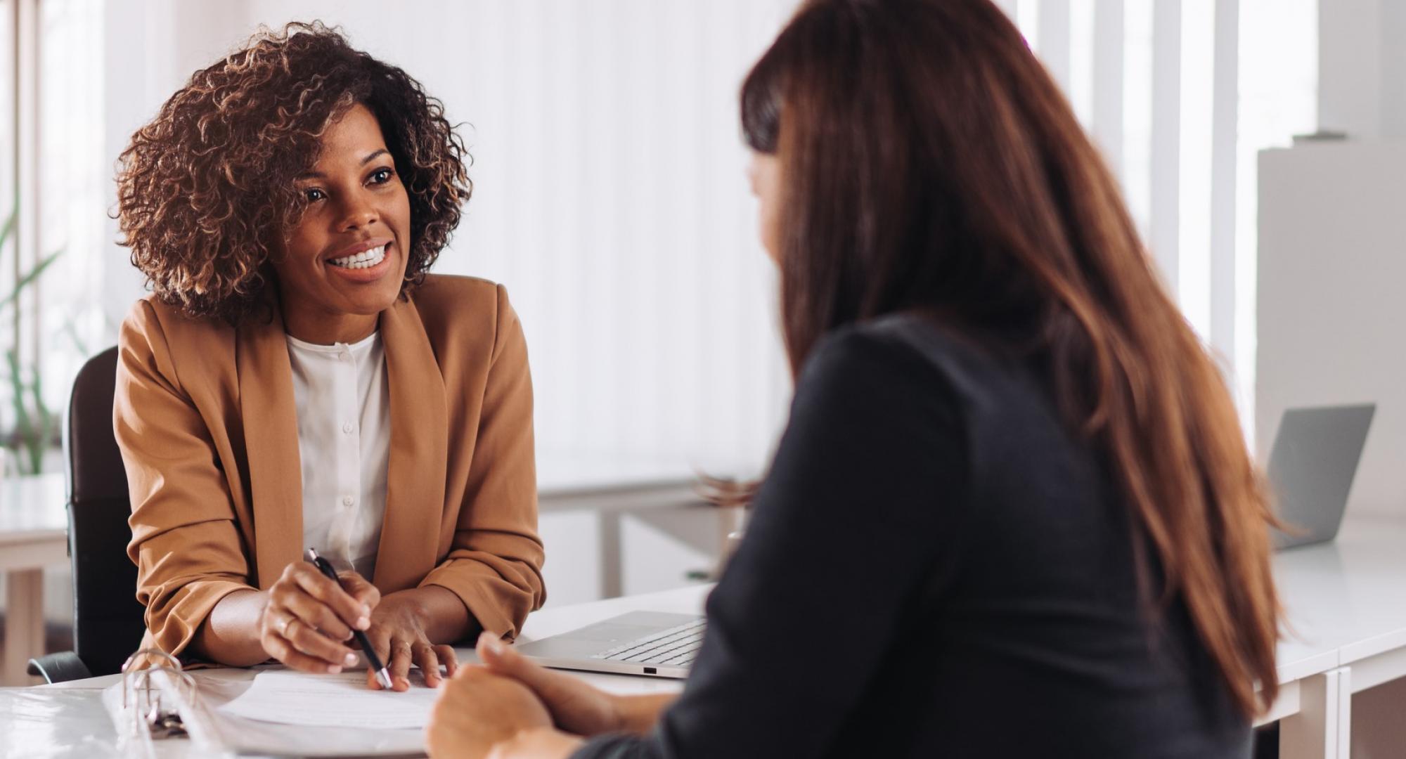 Youth worker offering careers advice to a young woman