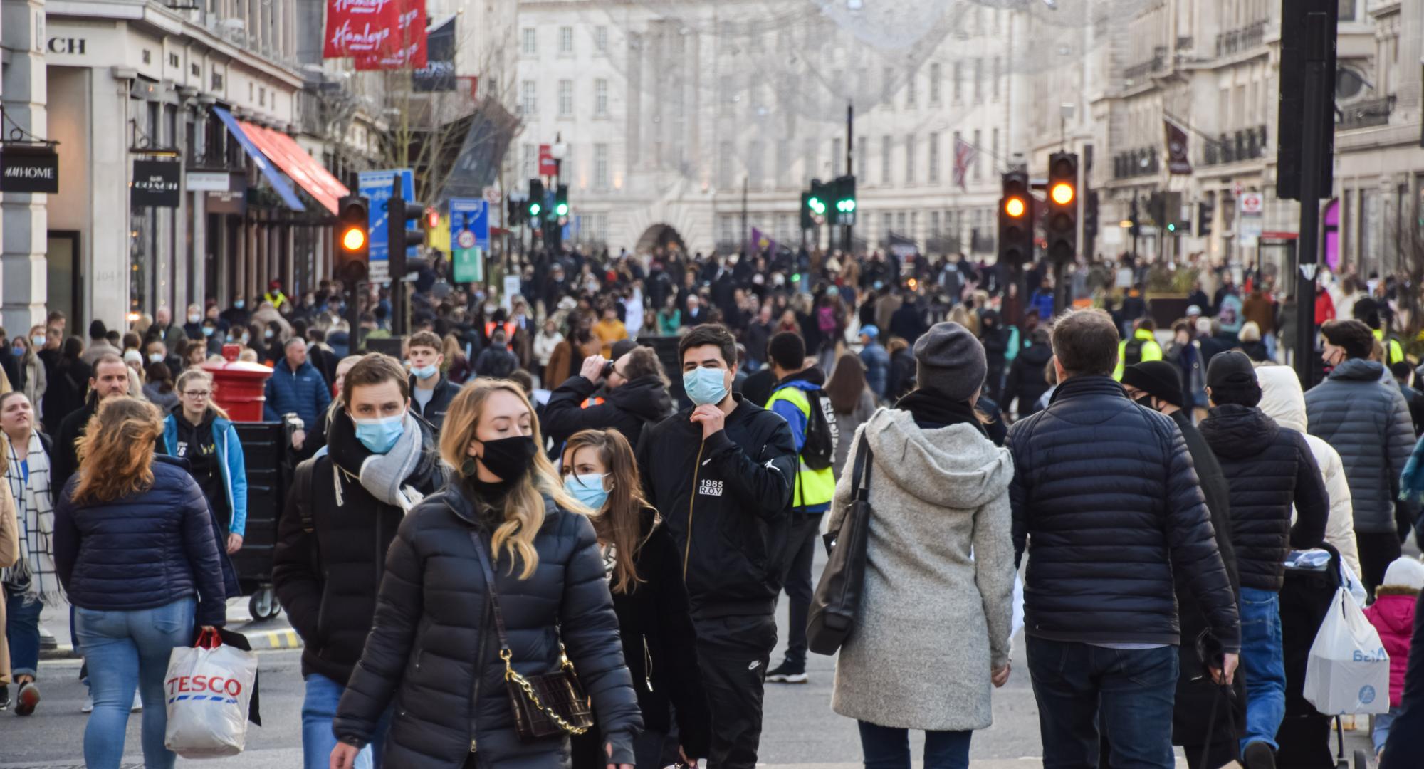 Busy London street with shoppers wearing face masks