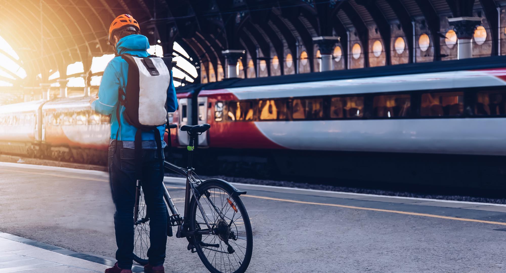 Man and bike, with train in background