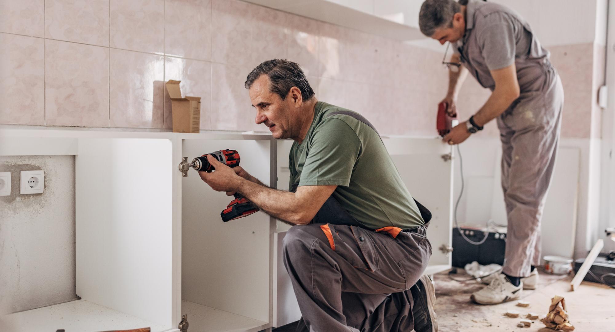 Kitchen being fitted in a council house