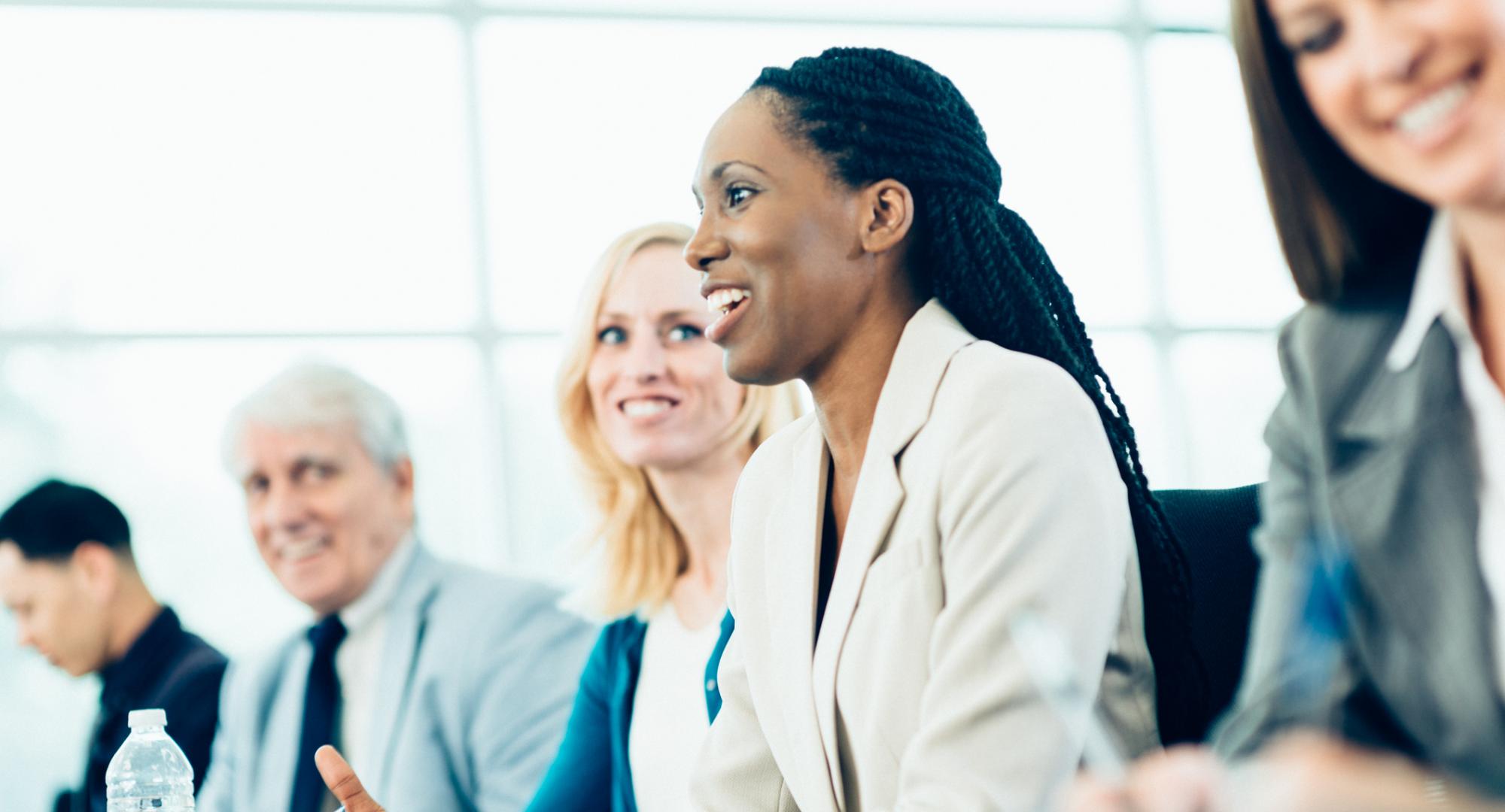 Woman on a panel talking at a meeting