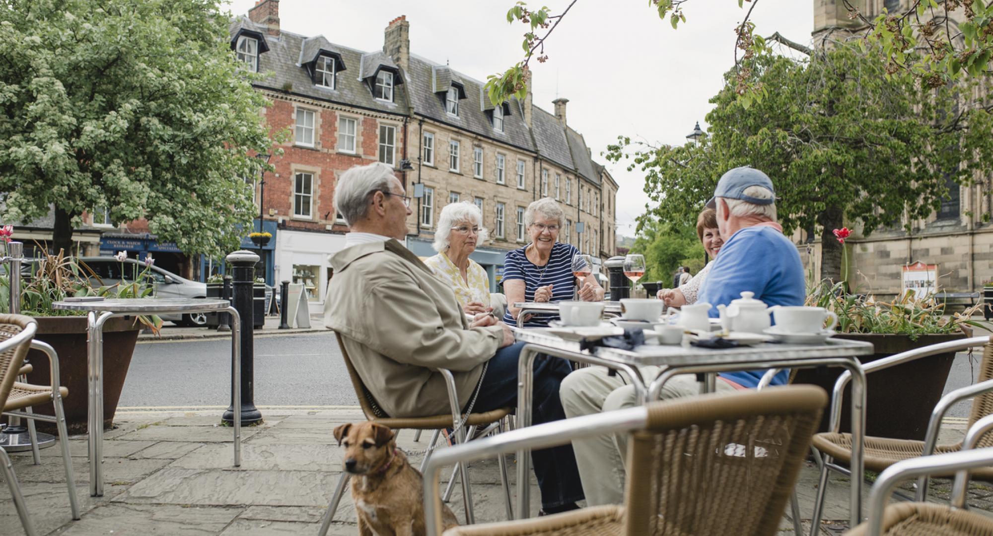 People sit outside a cafe in Hexham town centre