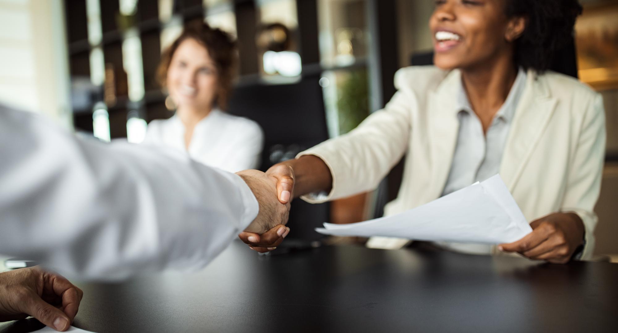 Young people shaking hands in an office