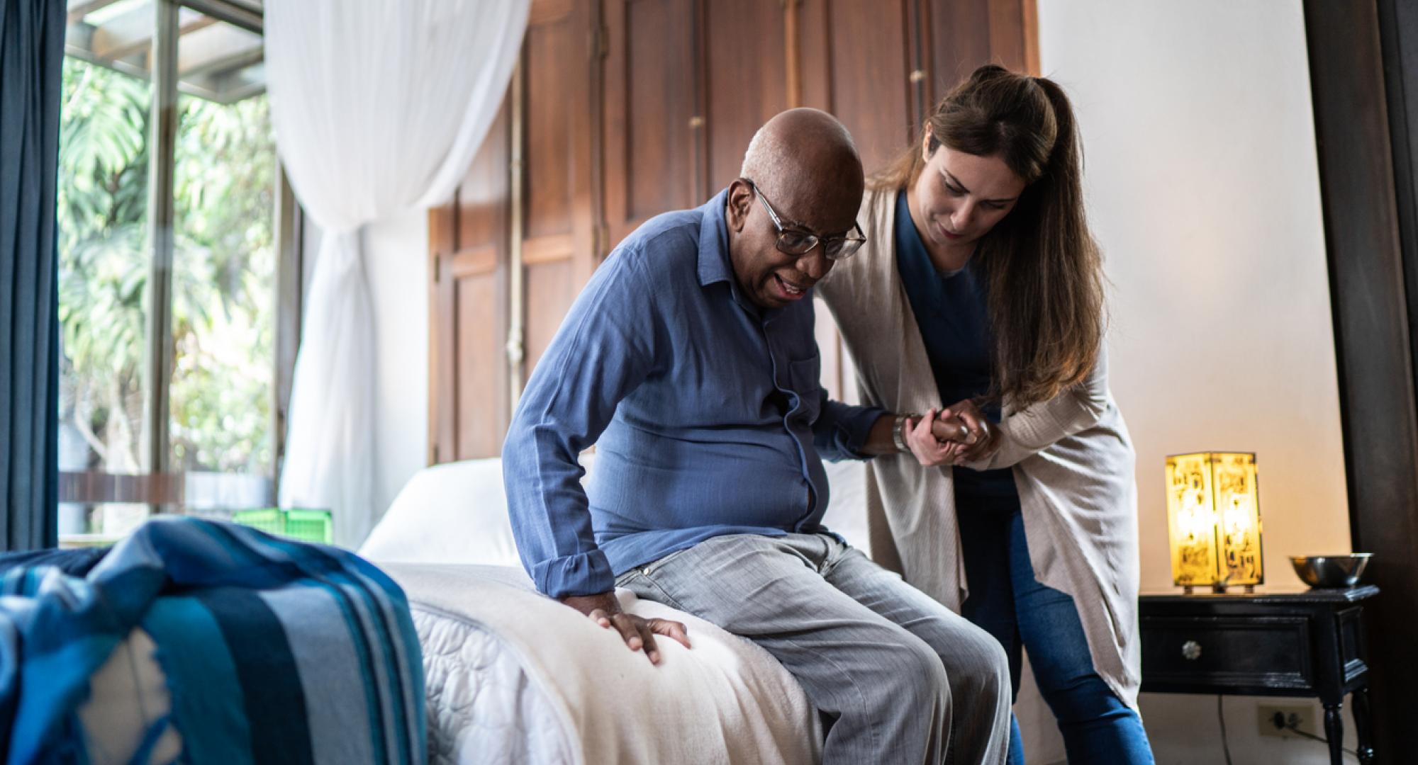 Woman giving care to an elderly man