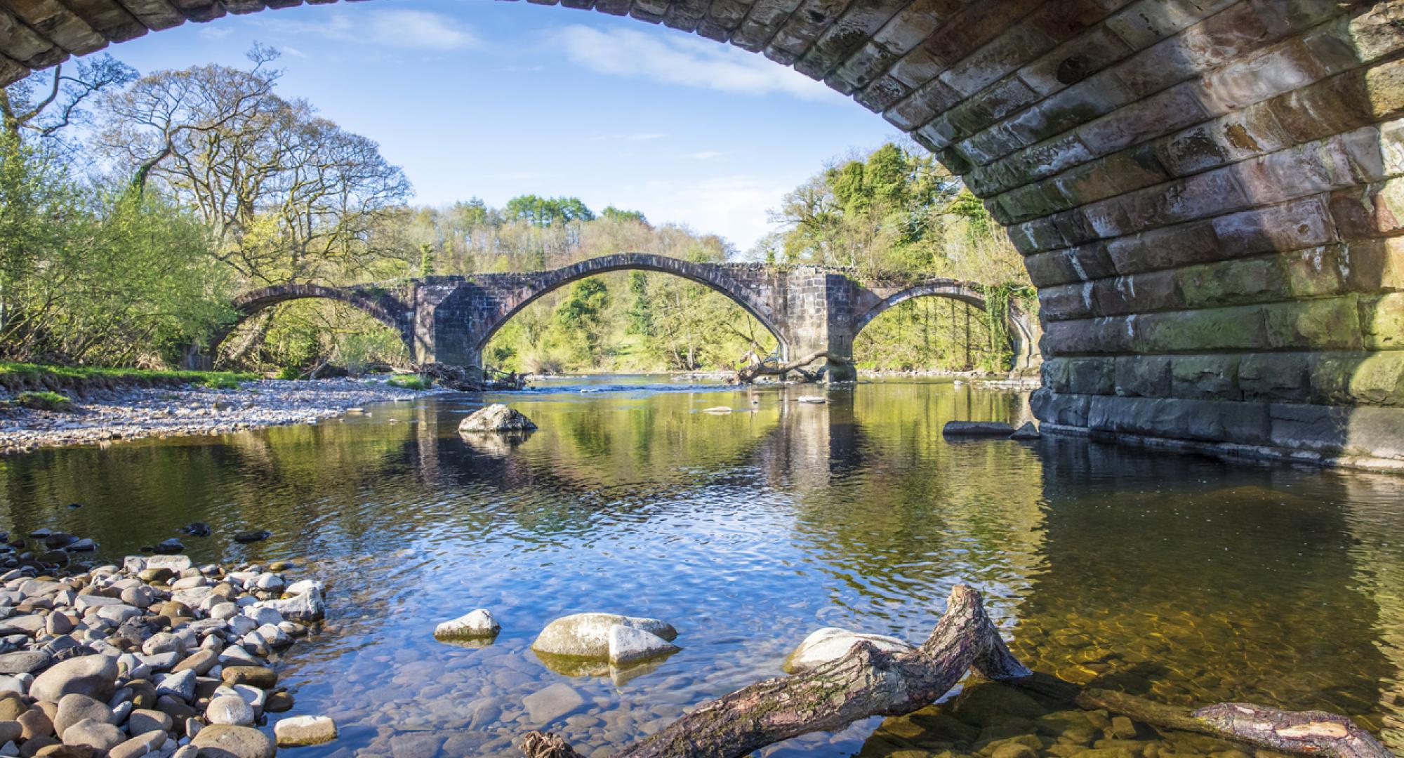 View of a river from underneath a bridge in Lancashire