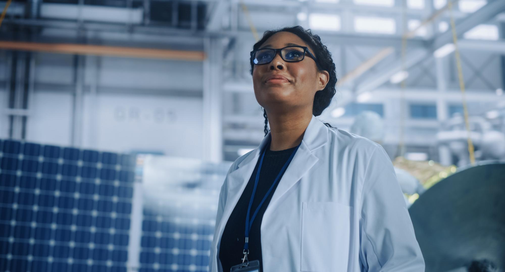 A female researcher is stood looking up