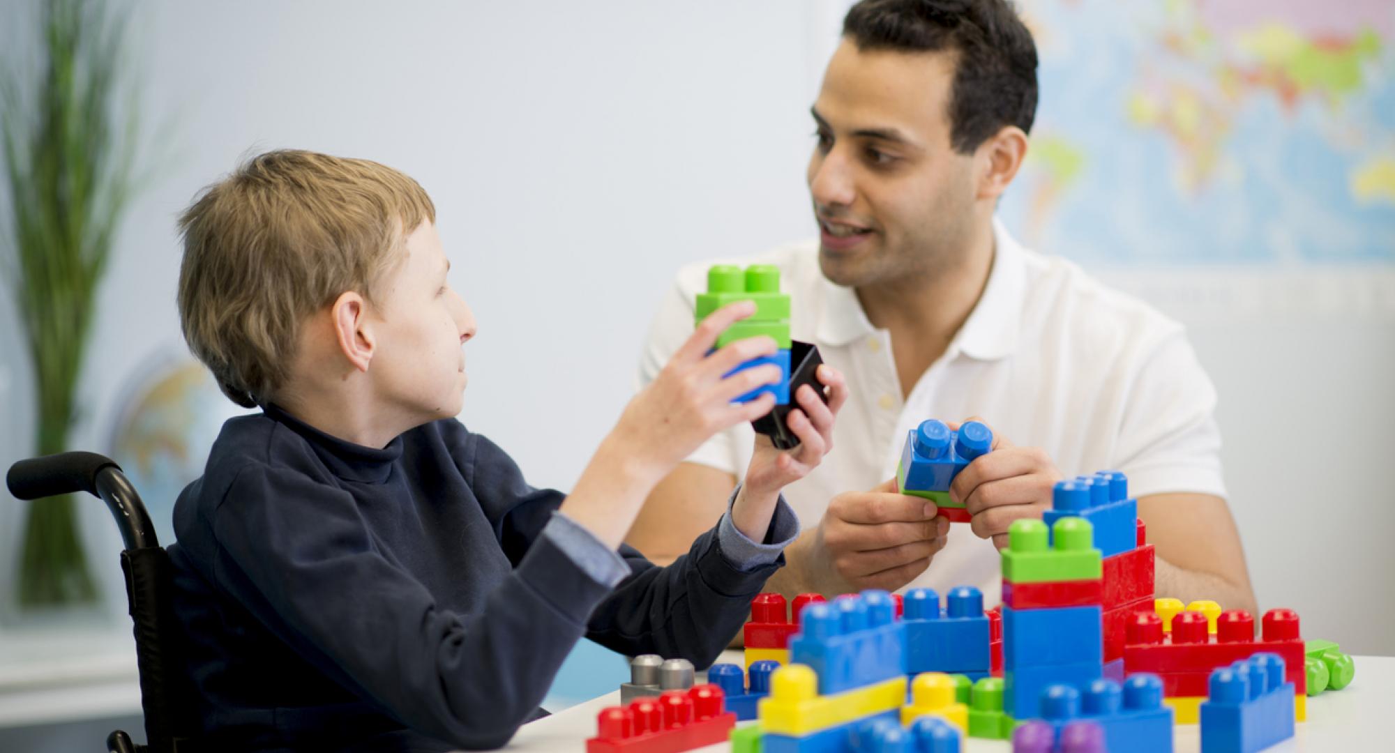 caregiver playing with a child with special needs