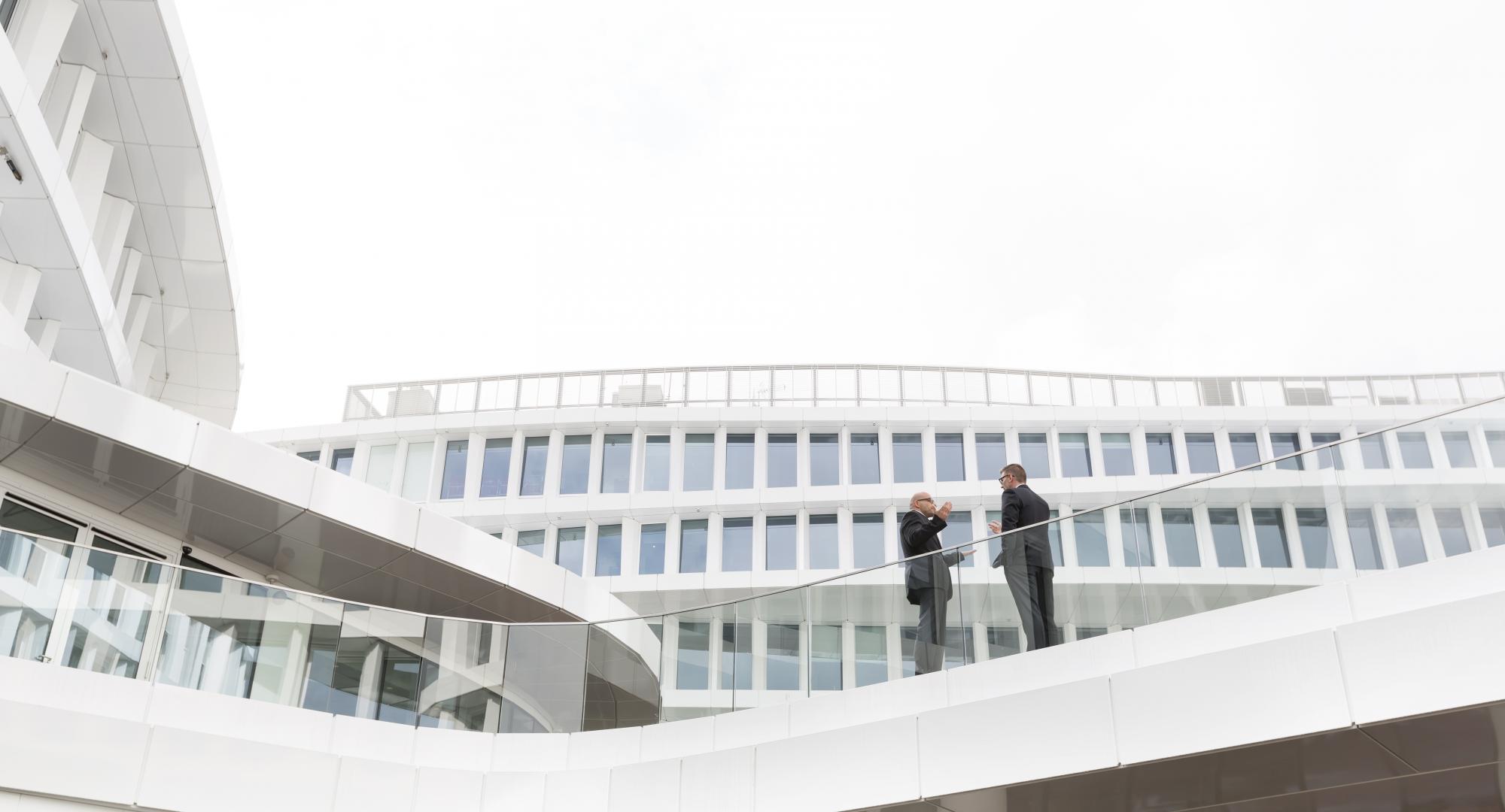 Two people stood outside a modern building