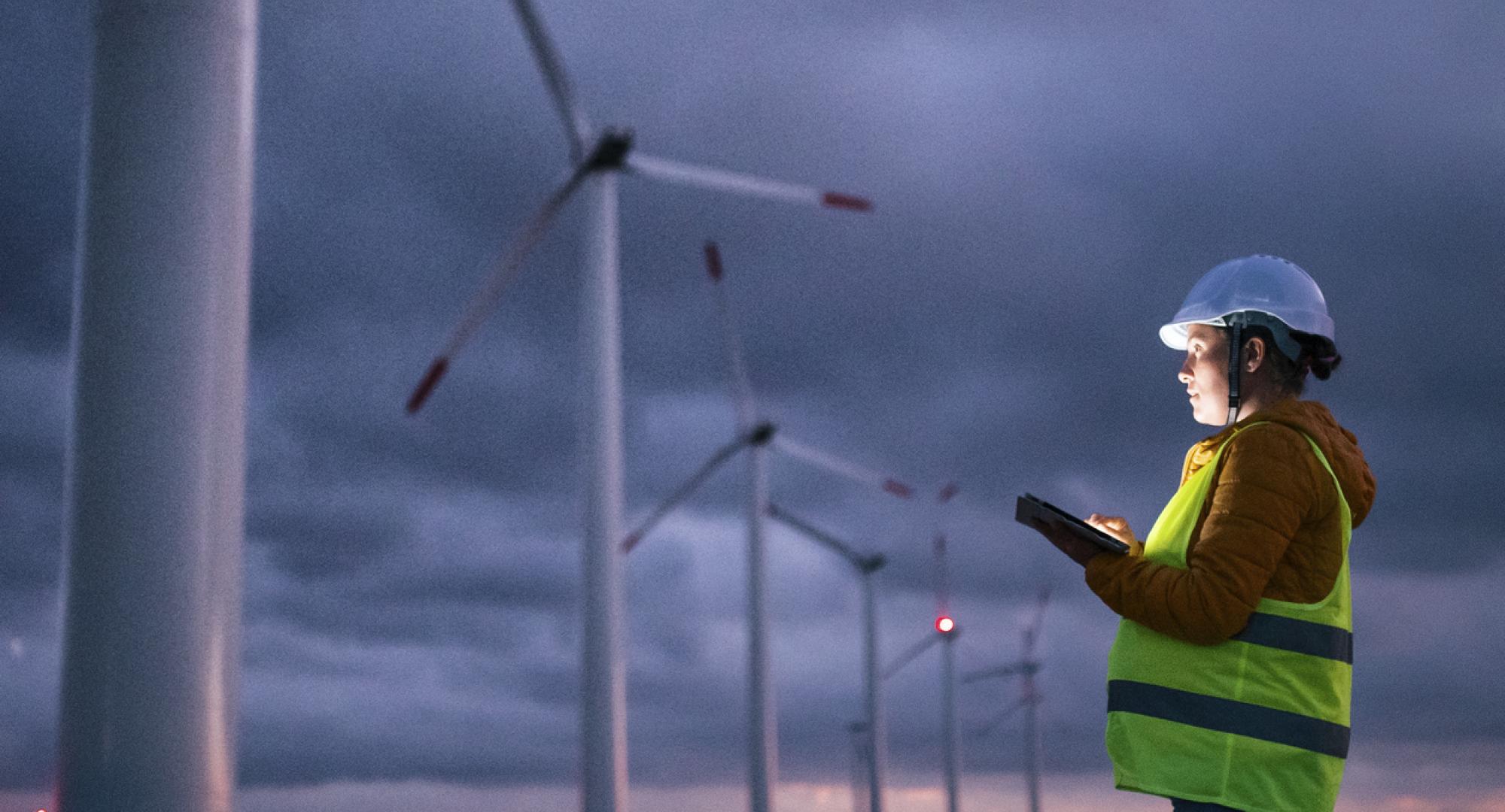 Woman observing wind turbines