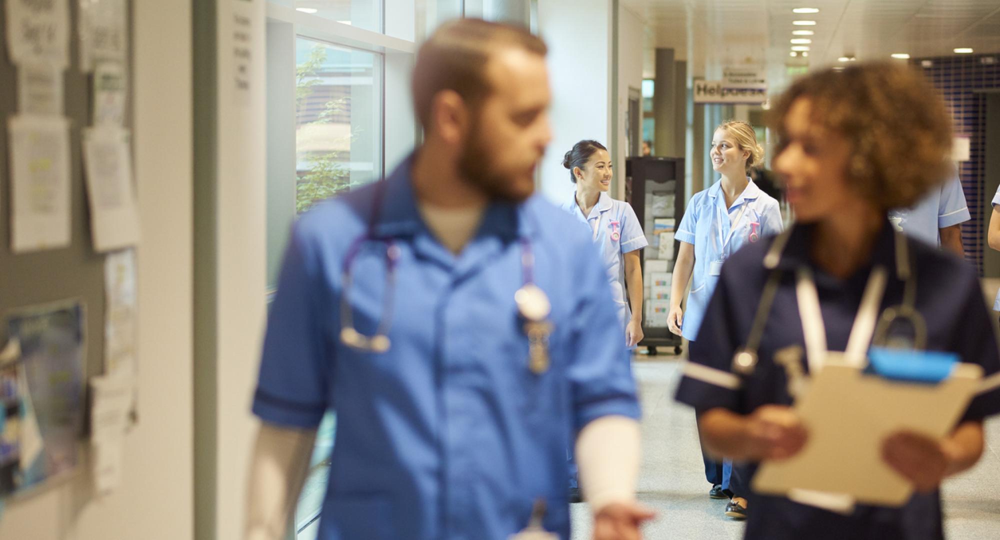 NHS nurses walking down a corridor