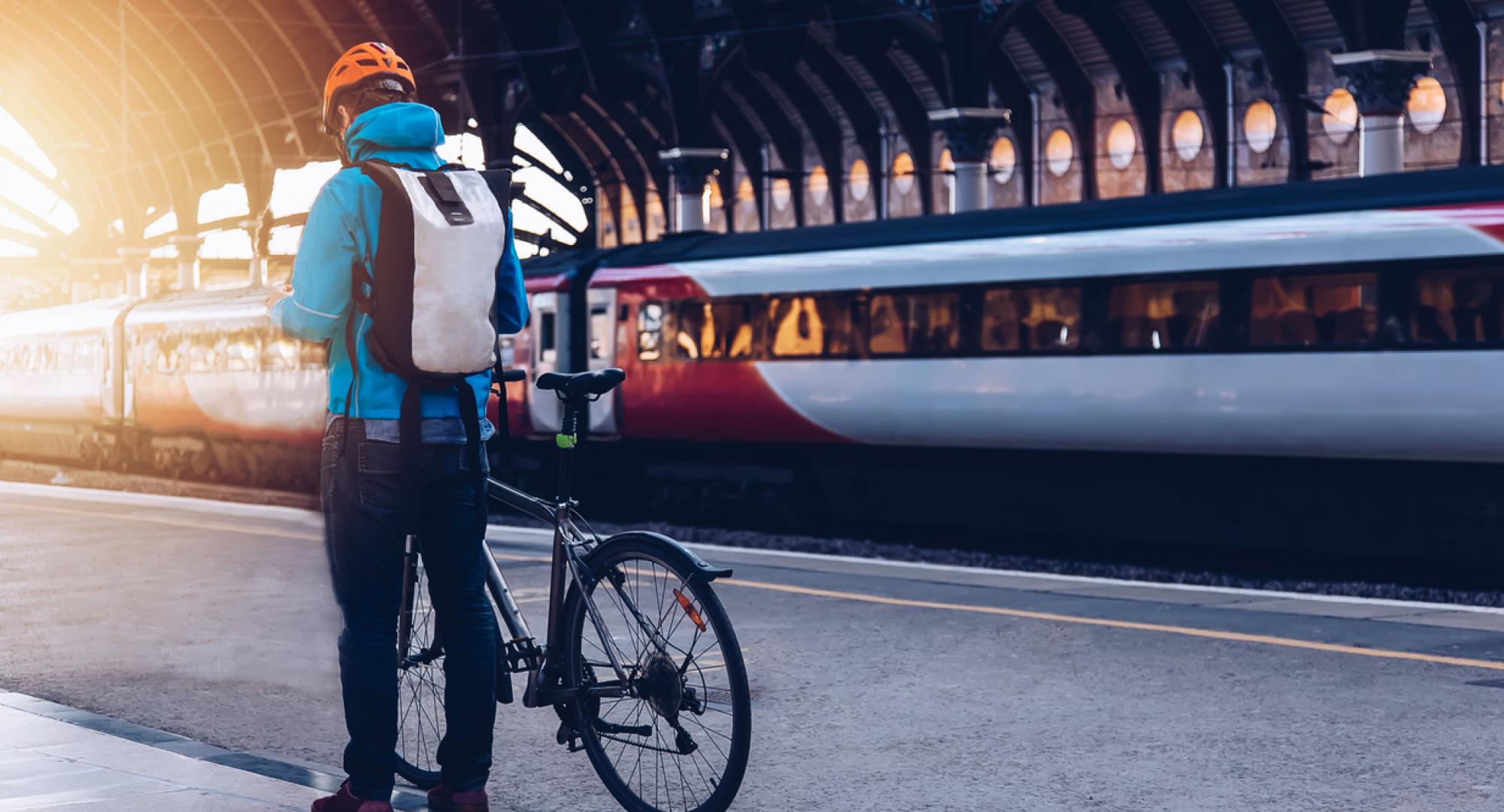 Man on a bike near a train
