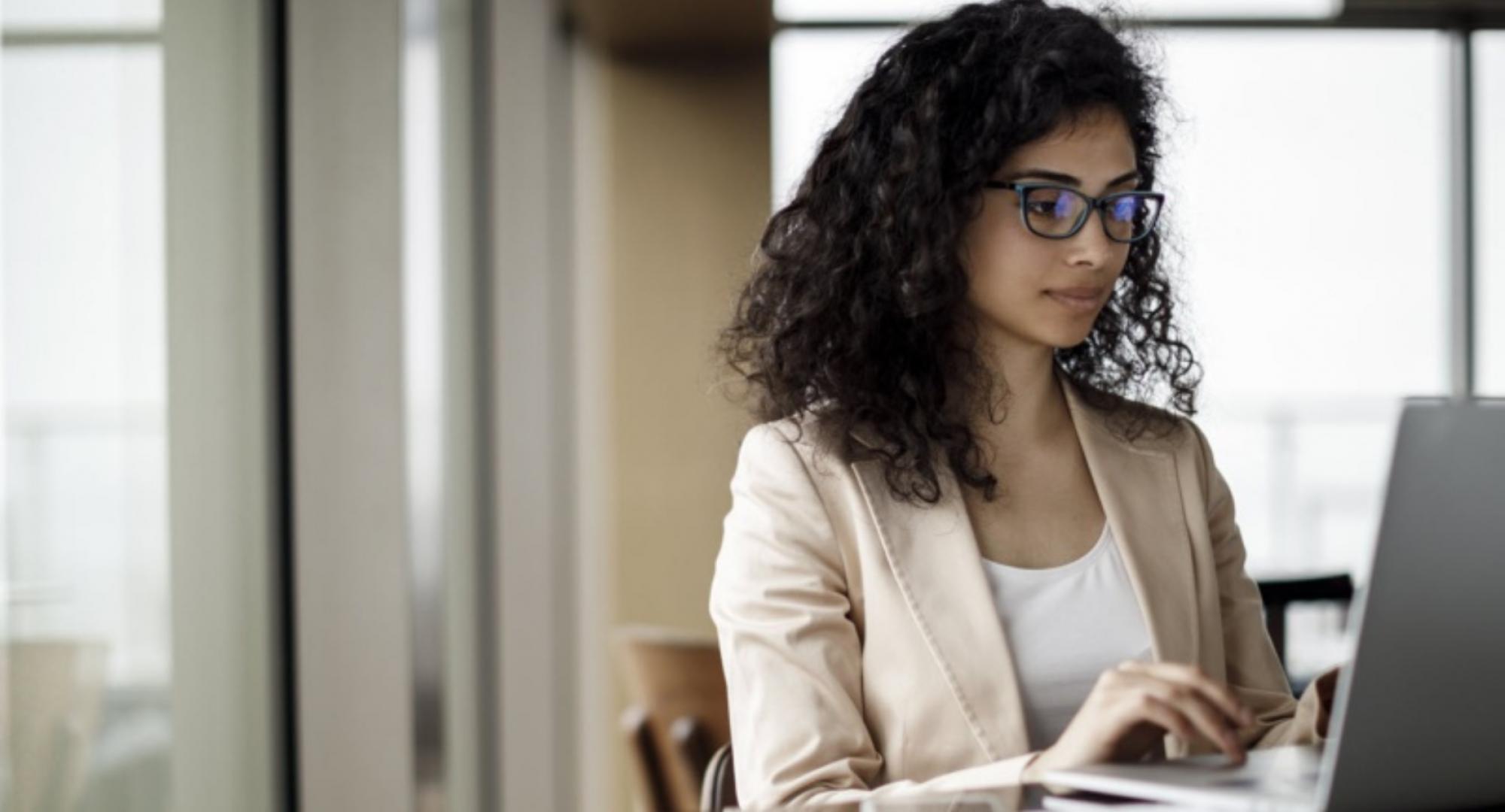 Photo of a woman working at a computer