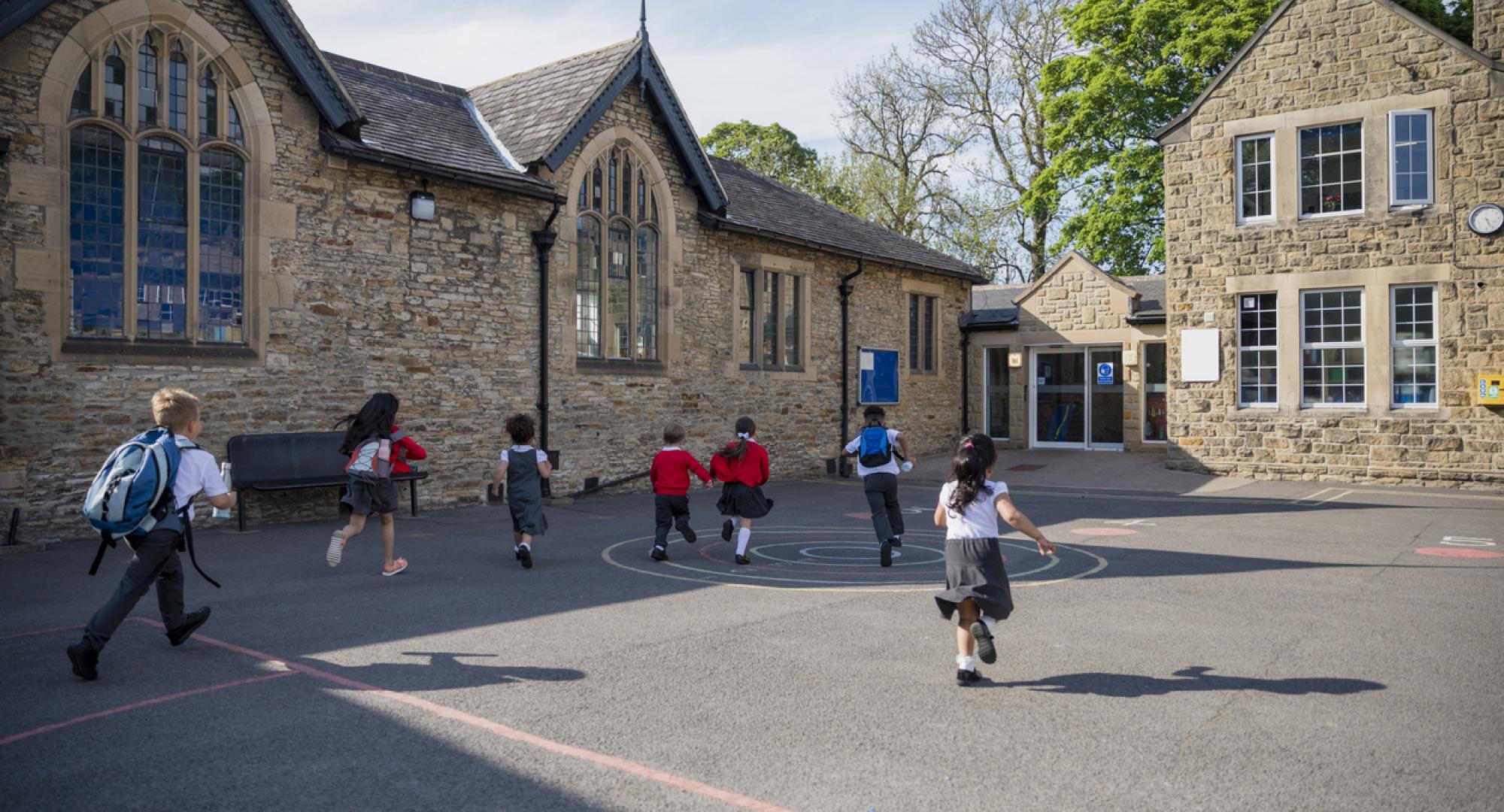 Children running through a playground of a primary school