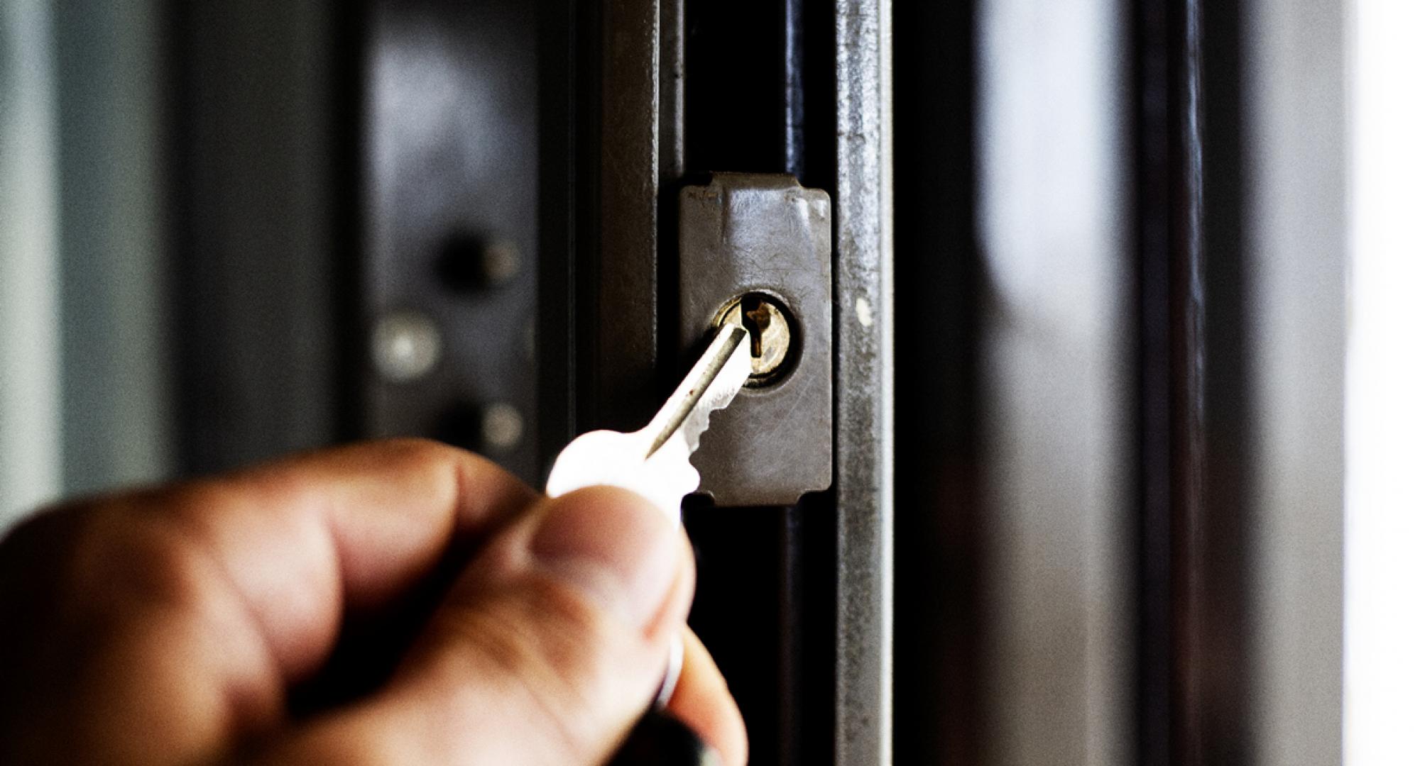 A key being put into a door