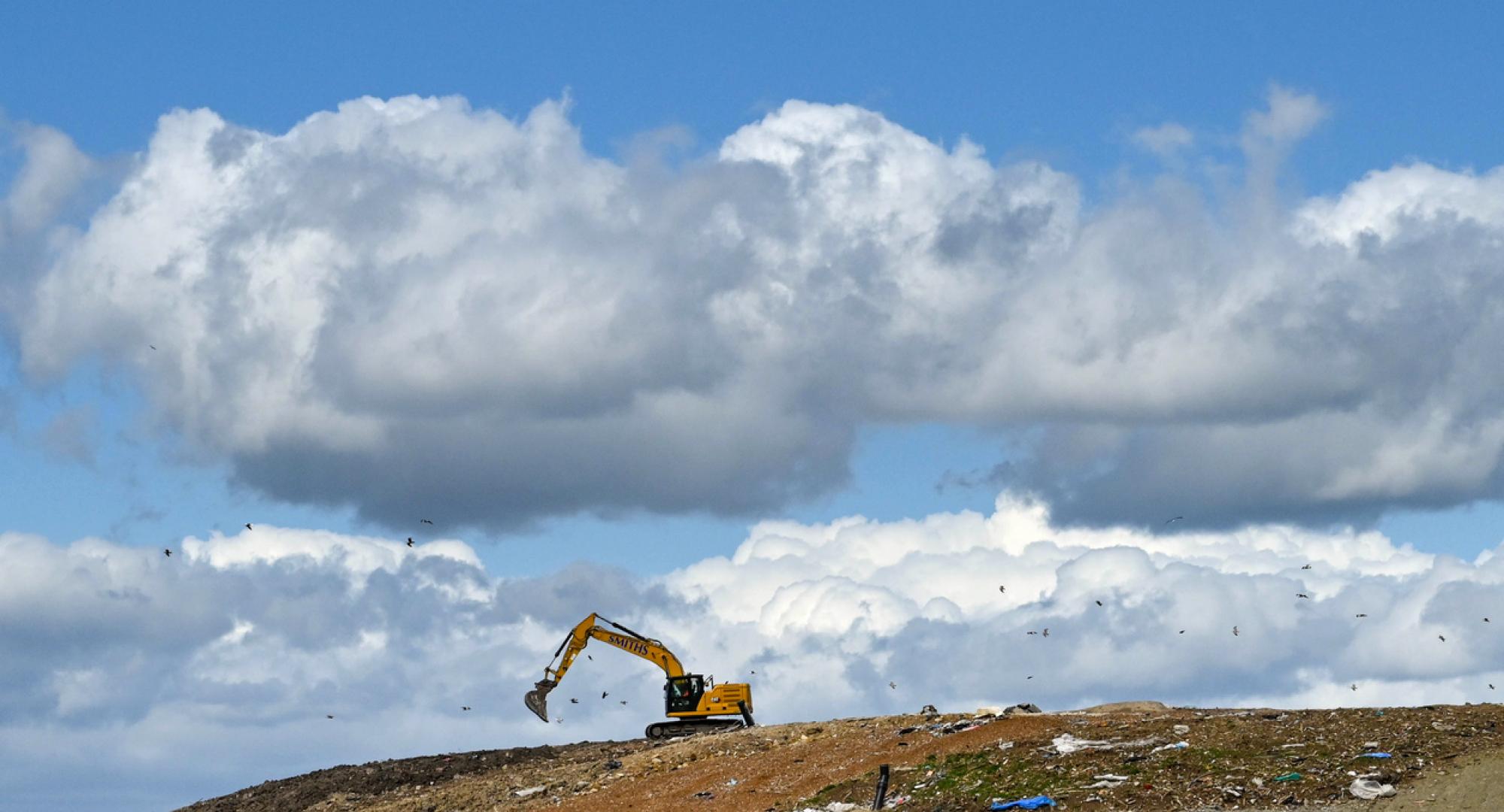 A digger on a landfill site