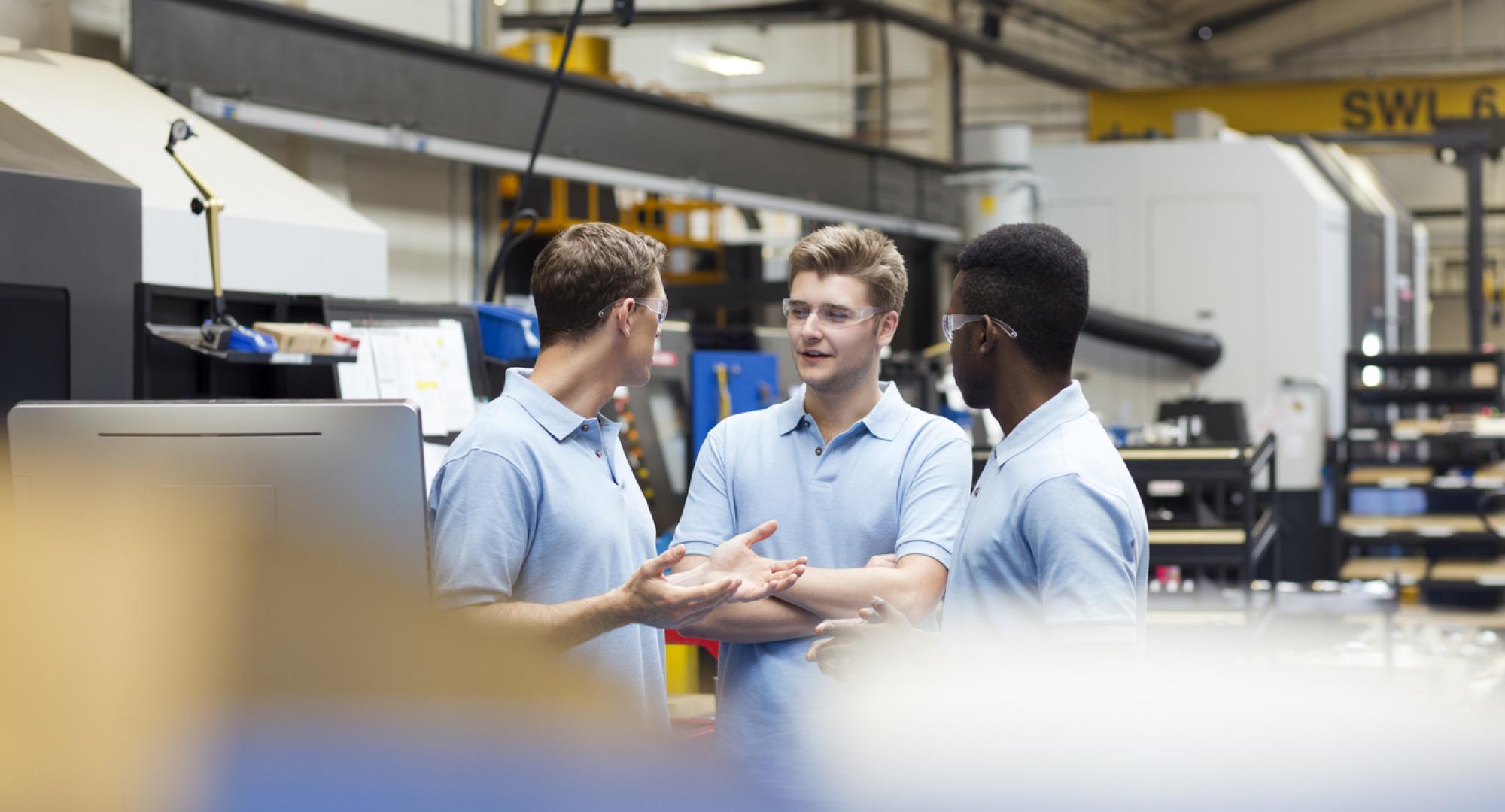 Three male apprentices discussing something