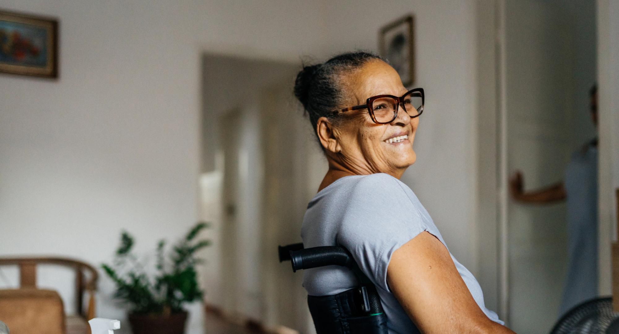 A woman in a wheelchair smiles