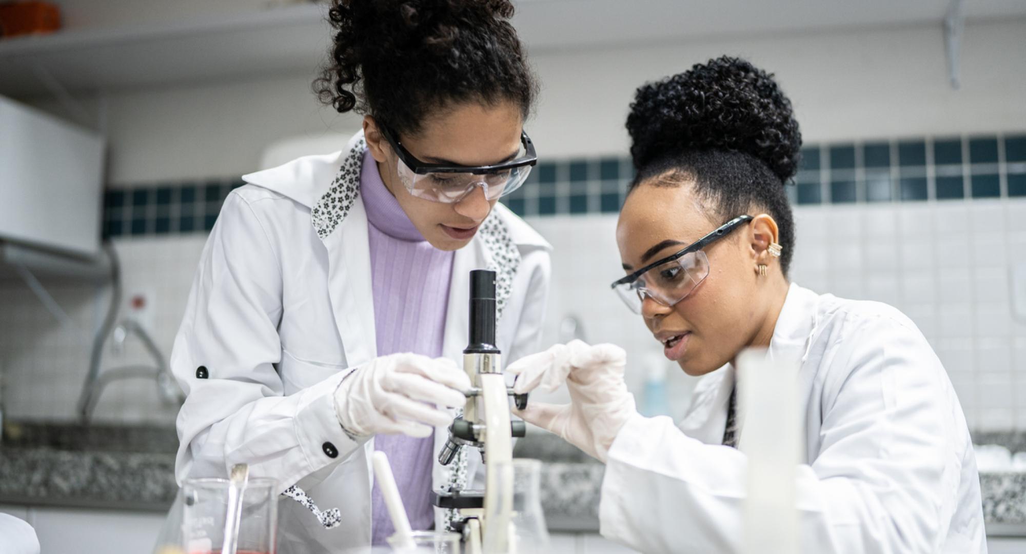 Teenage student using the microscope in the laboratory