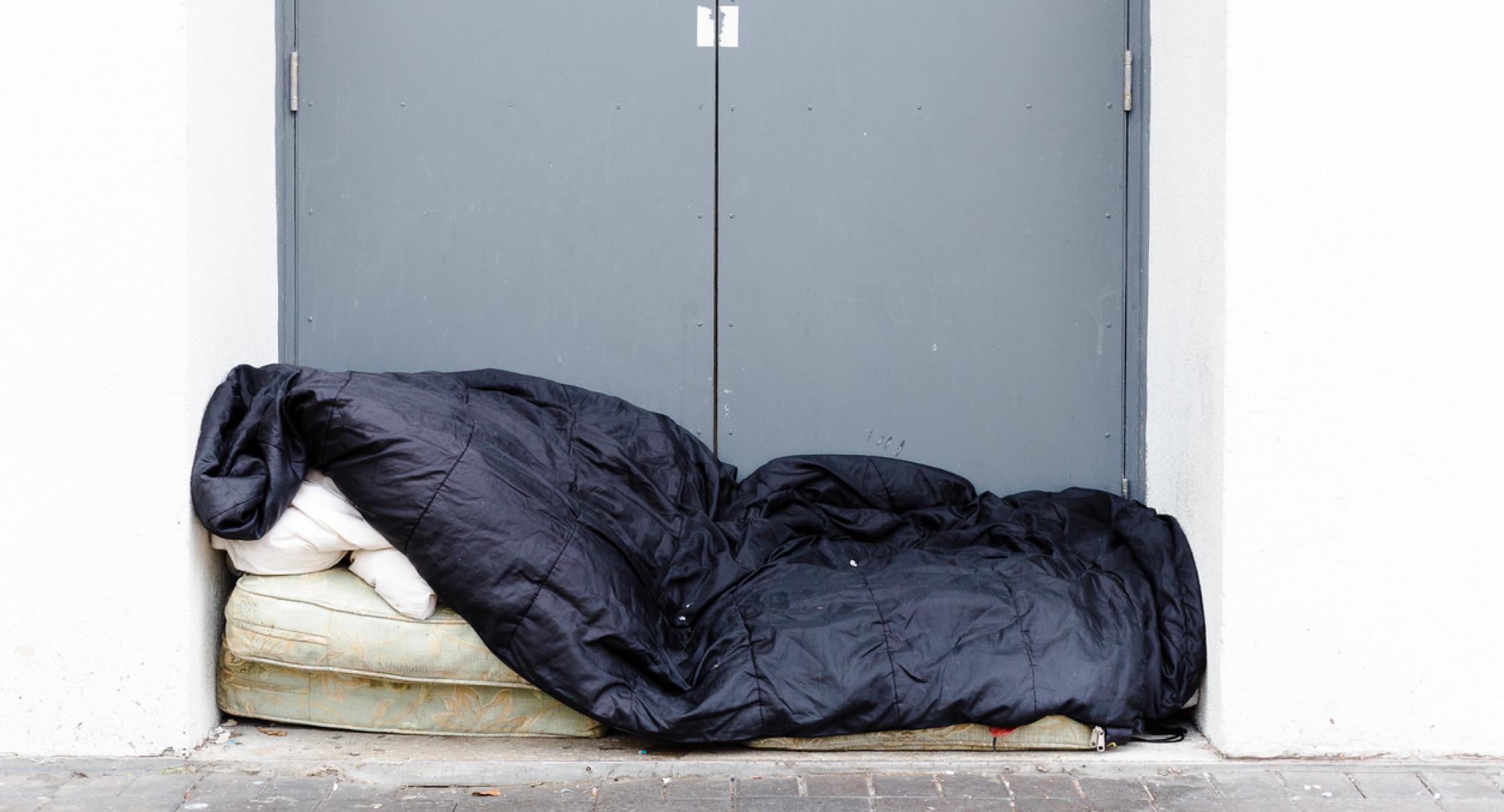 Man sleeping rough in a doorway