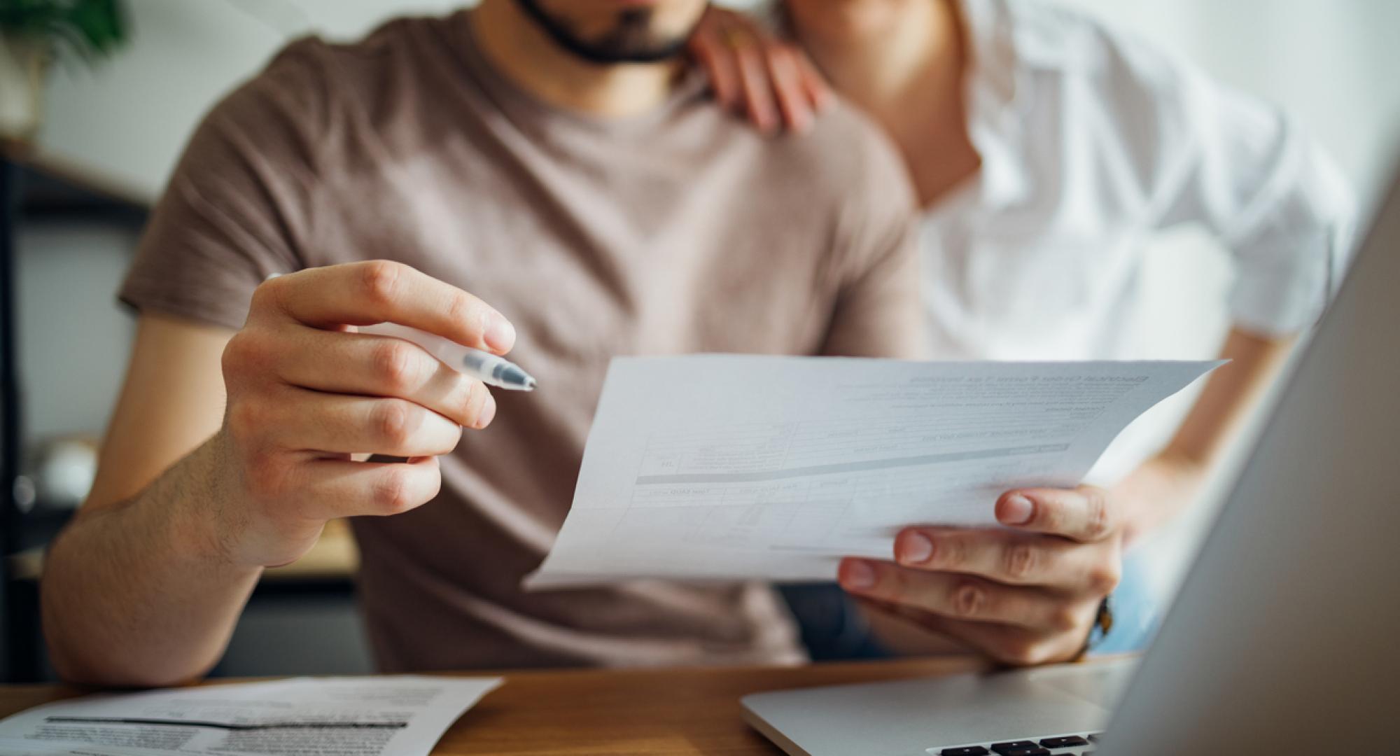 Couple managing bills with a computer