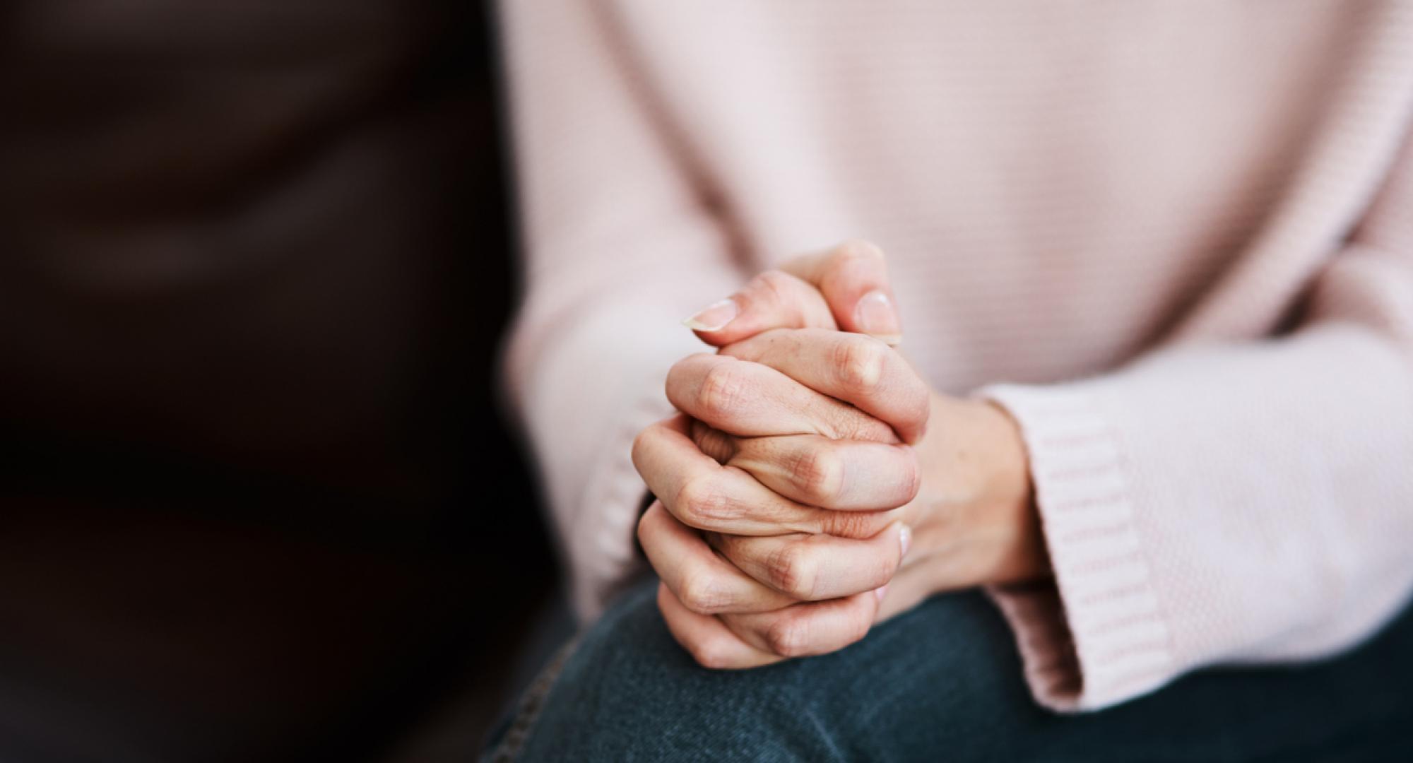 Cropped shot of a woman sitting on a sofa and feeling anxious