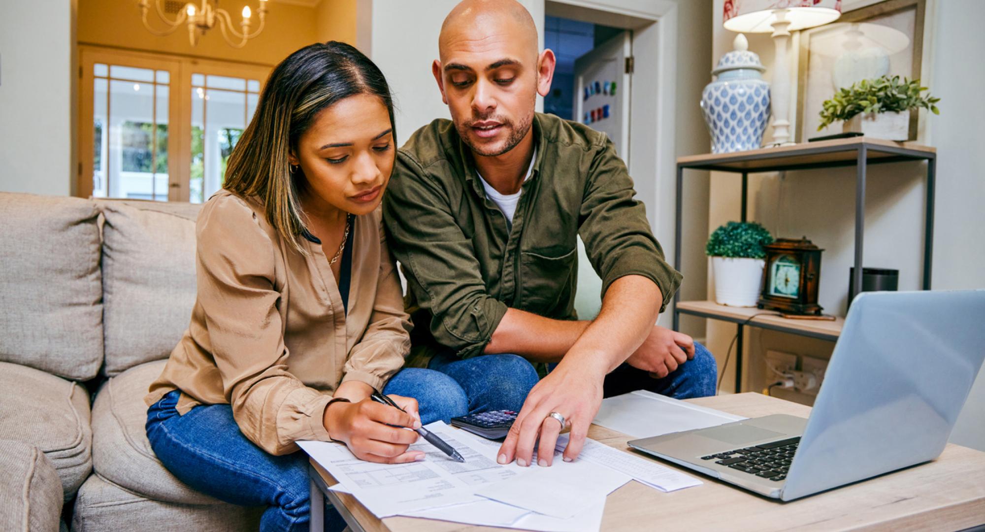 A couple looking through budgeting and bills