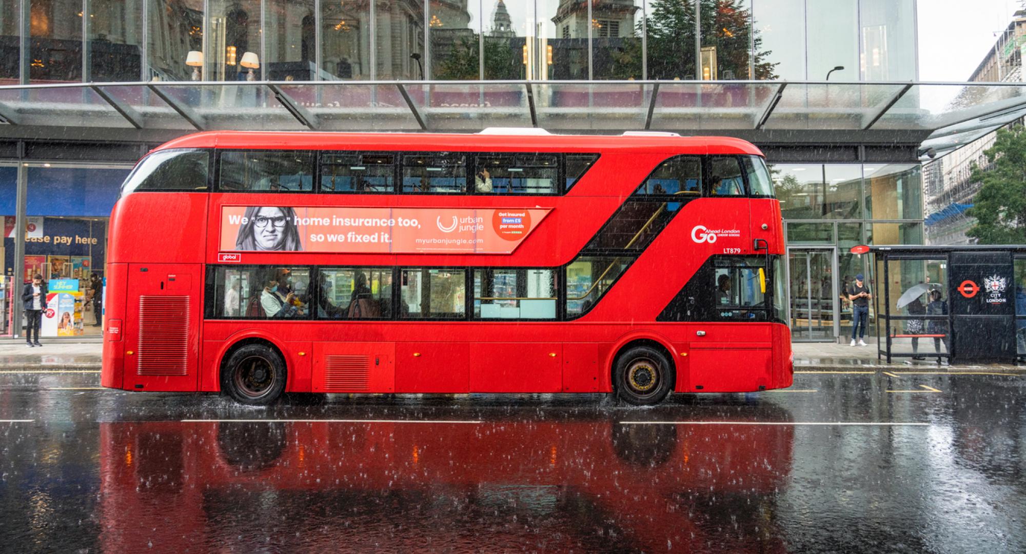 Side view of a london bus in the rain