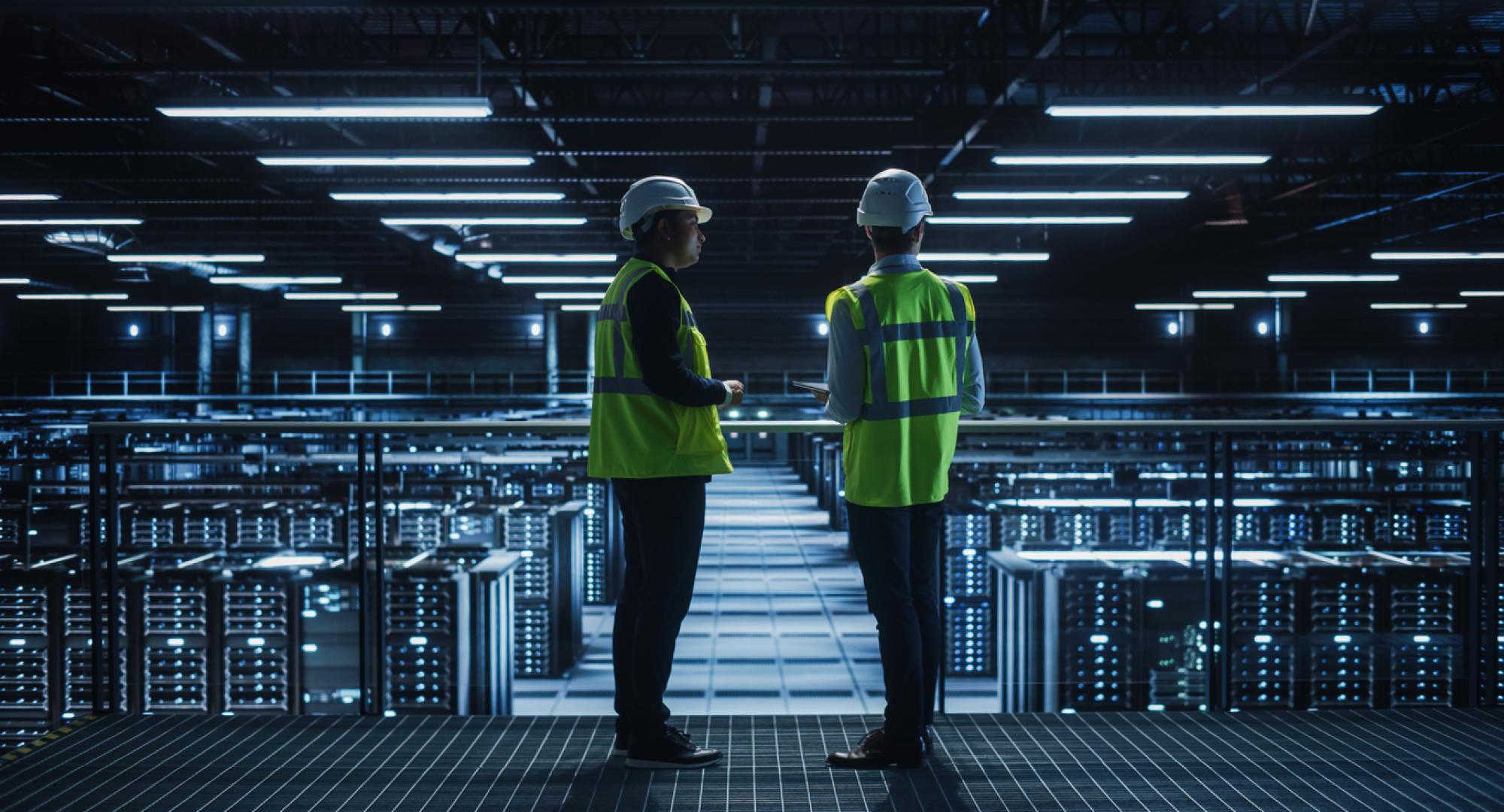 Two people standing in a datacentre