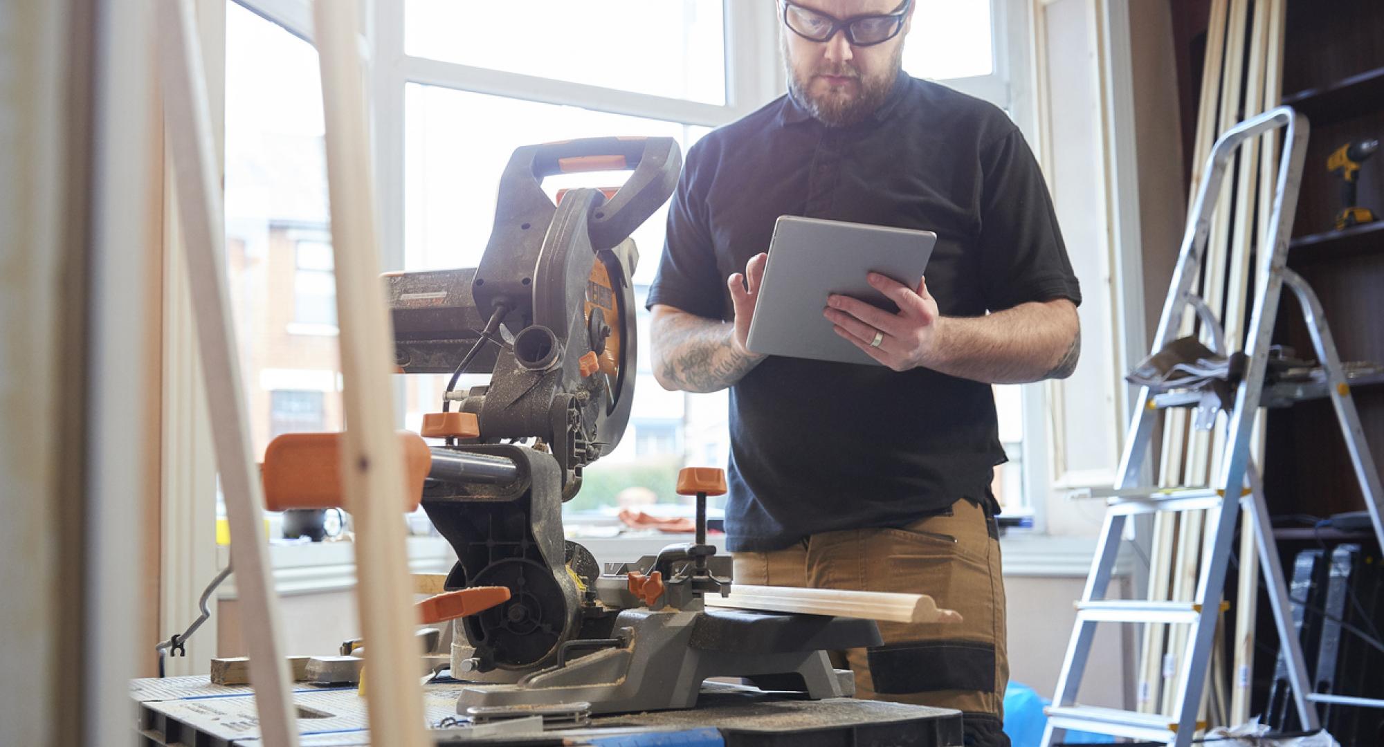 Self-employed person working on a tablet. Tradesman.