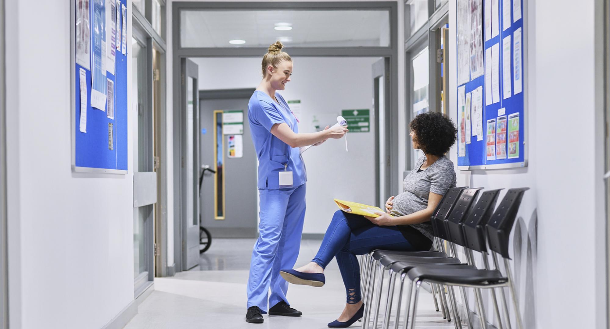 NHS nurse talking to a pregnant patient