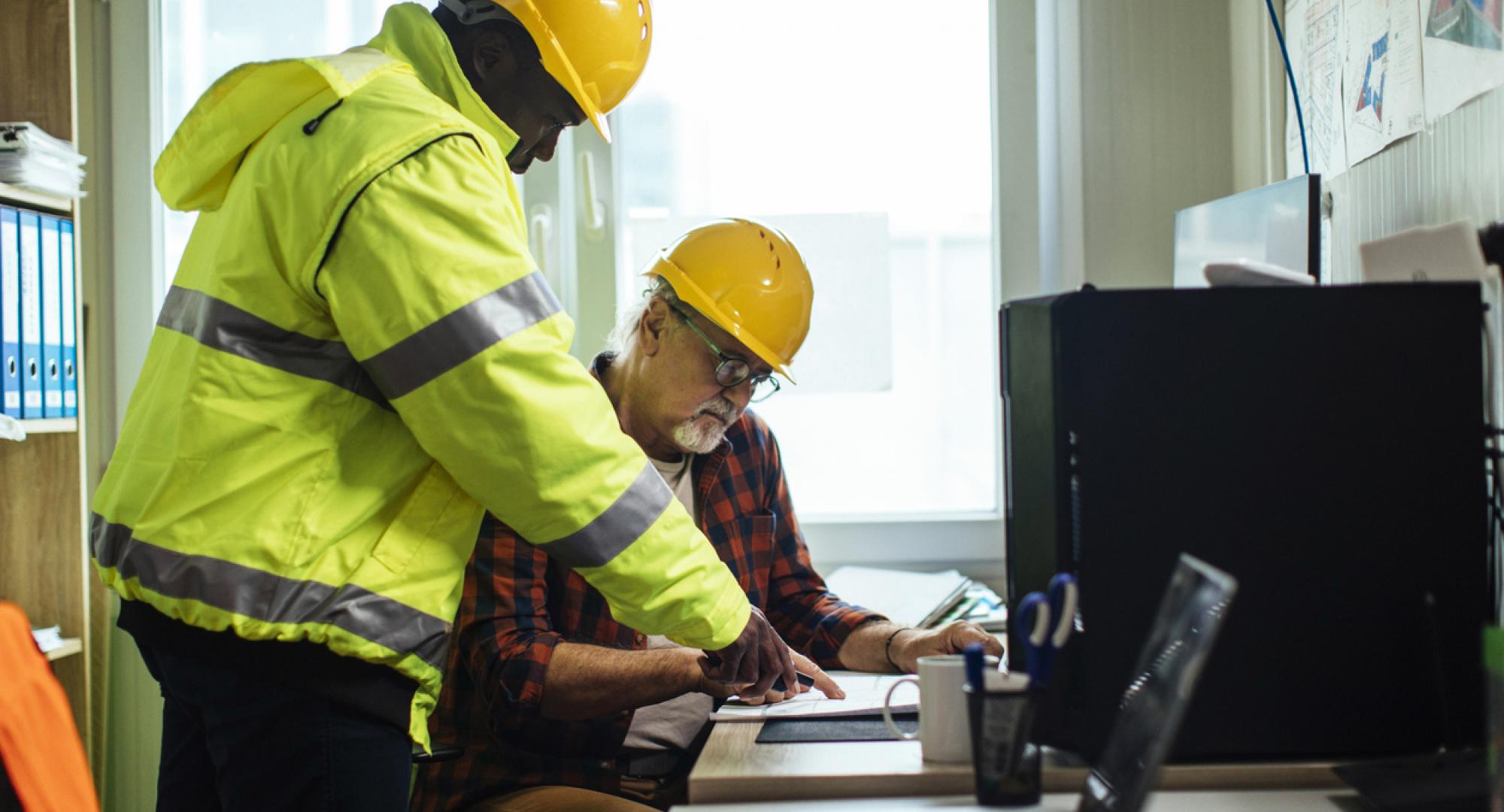 Two engineers working through plans