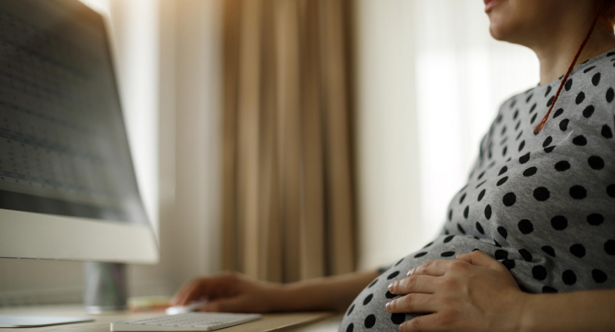 Pregnant woman working on computer