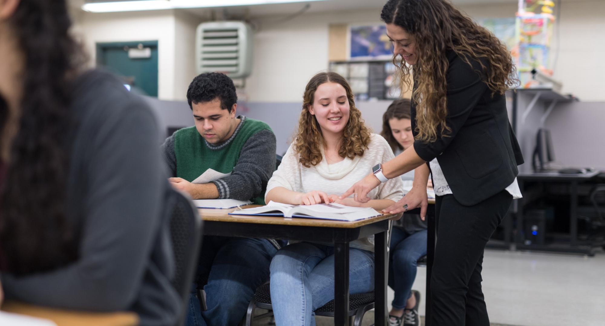 Teacher talks to older students 