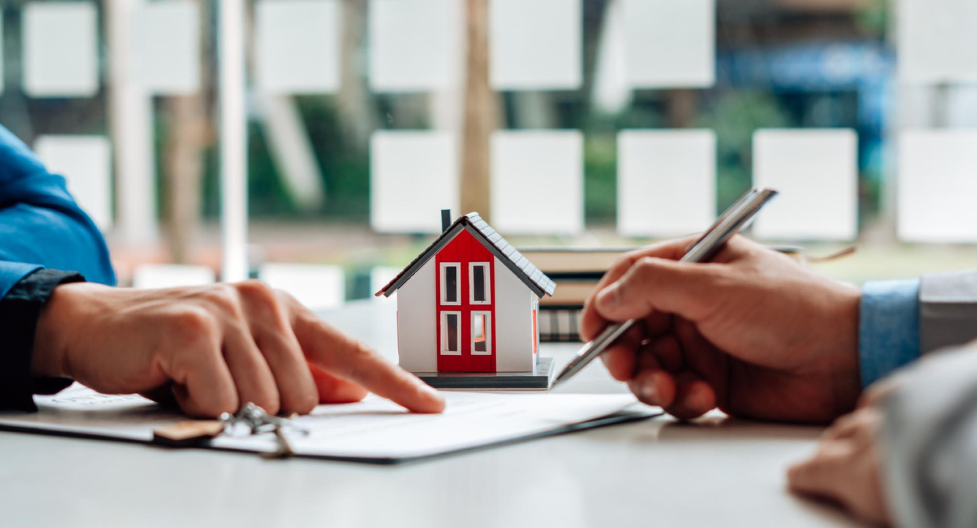 Two people signing a tenancy agreement