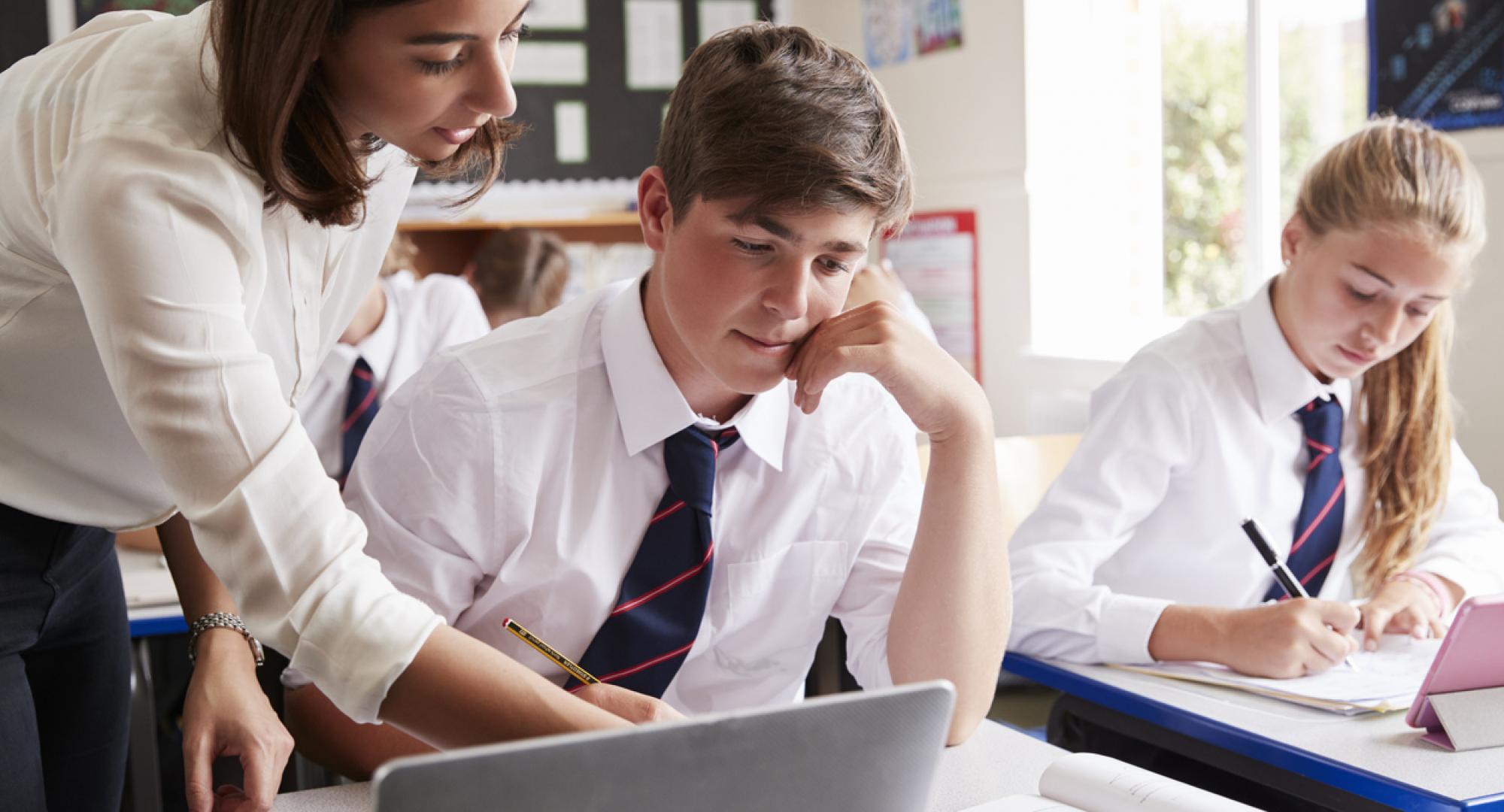 Teacher helping a student with his work