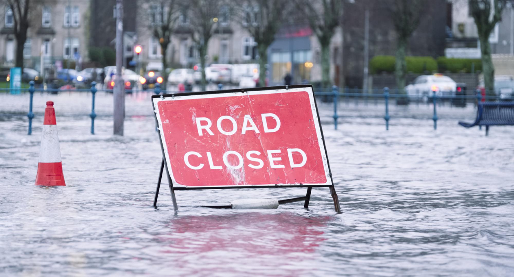 Road closed sign in a flooded street