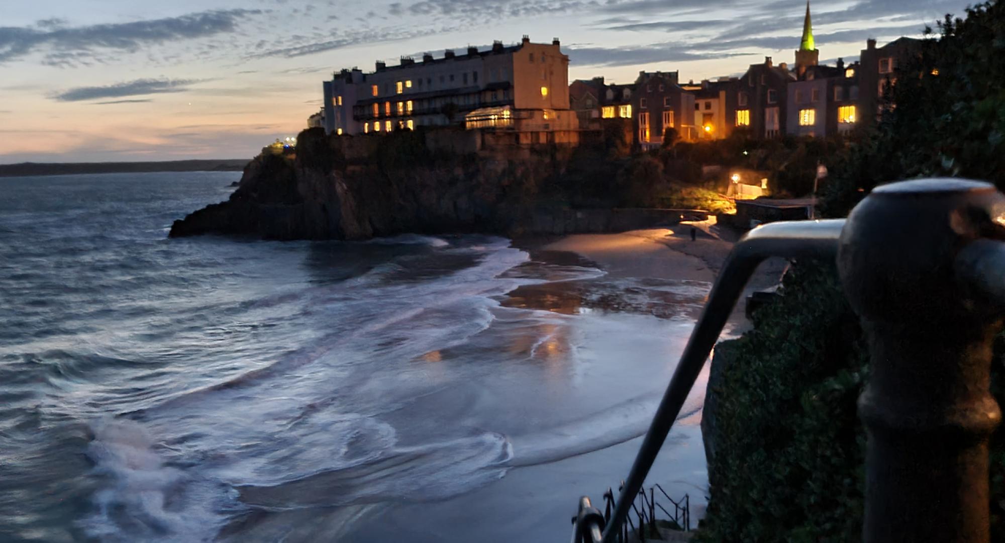 Sunset view of houses at the top of cliffs in Tenby