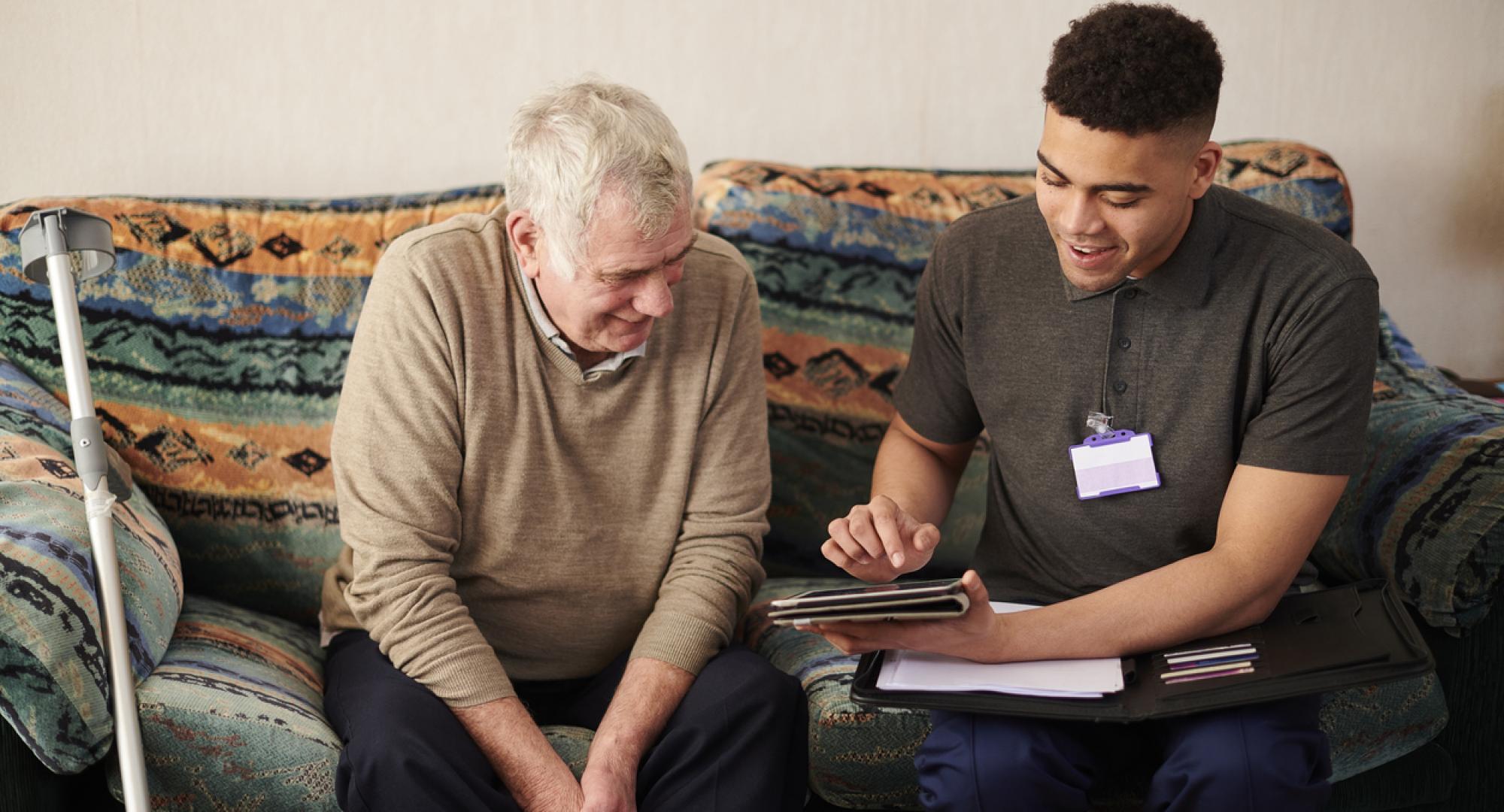 Carer using an iPad with a patient