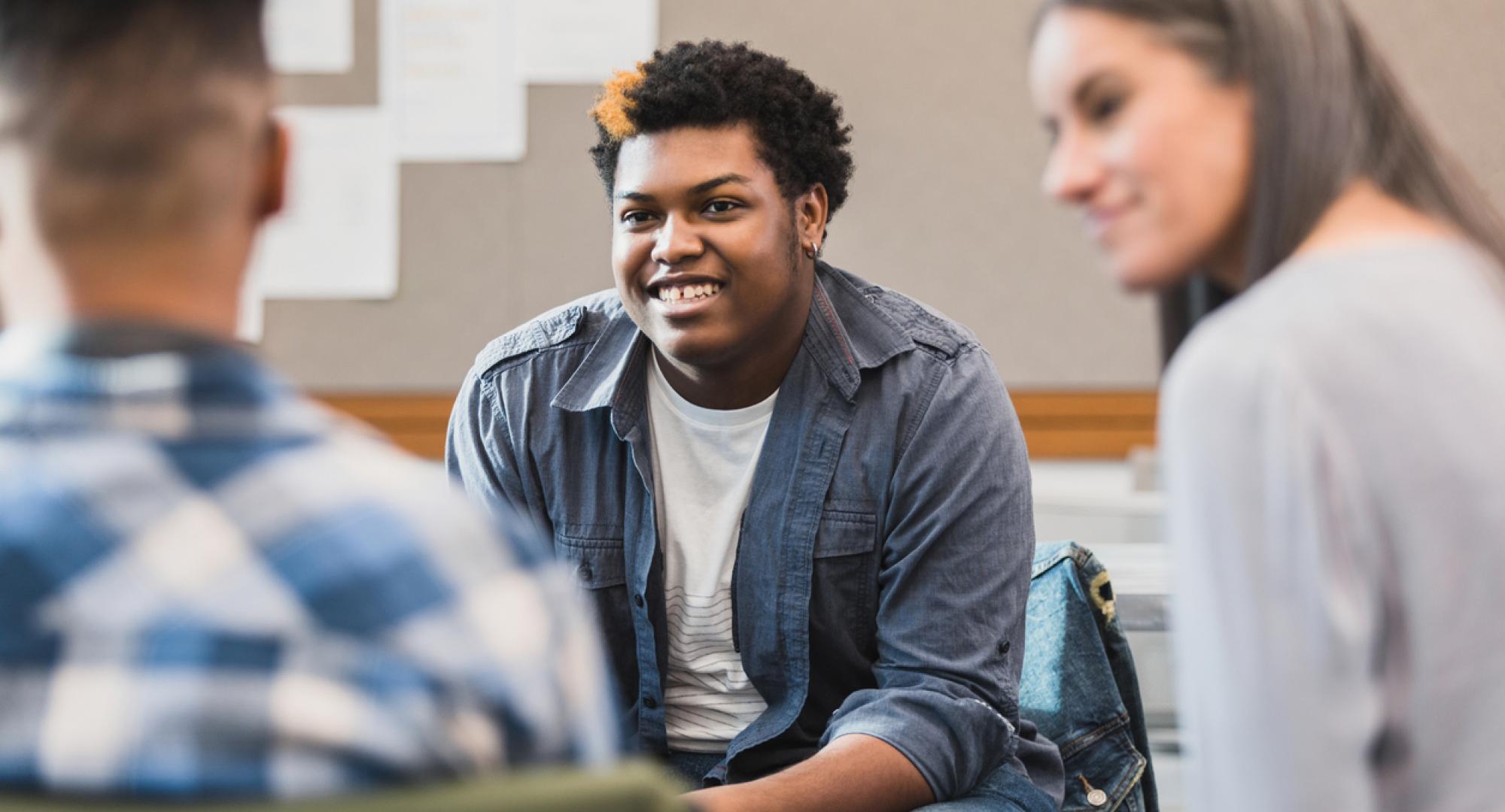 Young person talking to adults