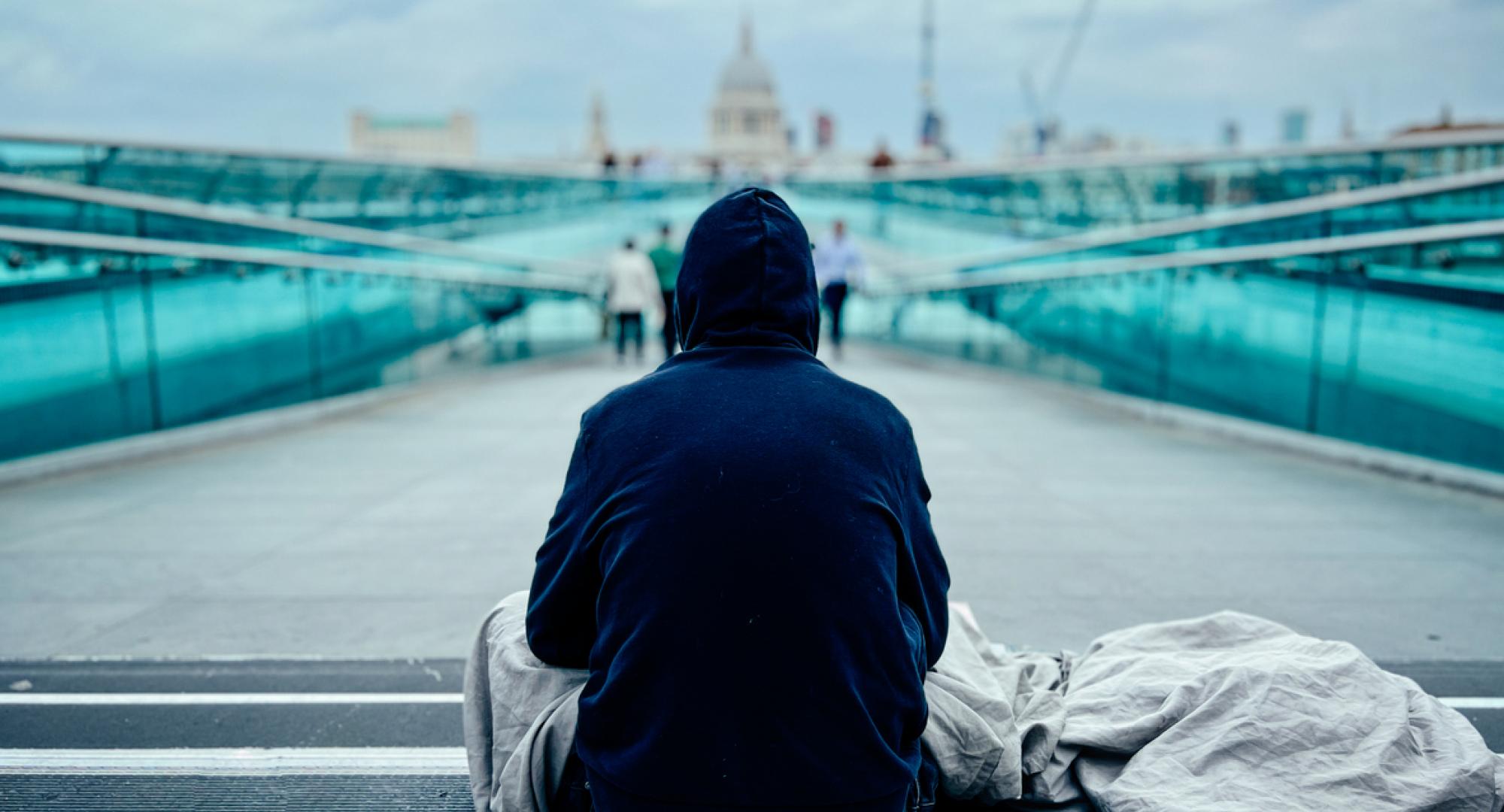 Homeless man in London with St Paul's Cathedral in the background