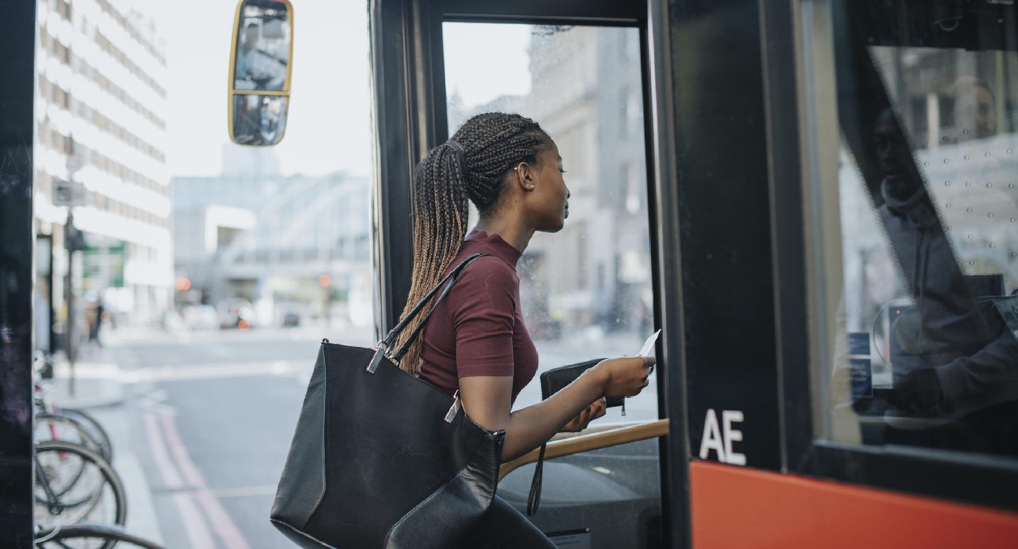 Woman getting onto a bus